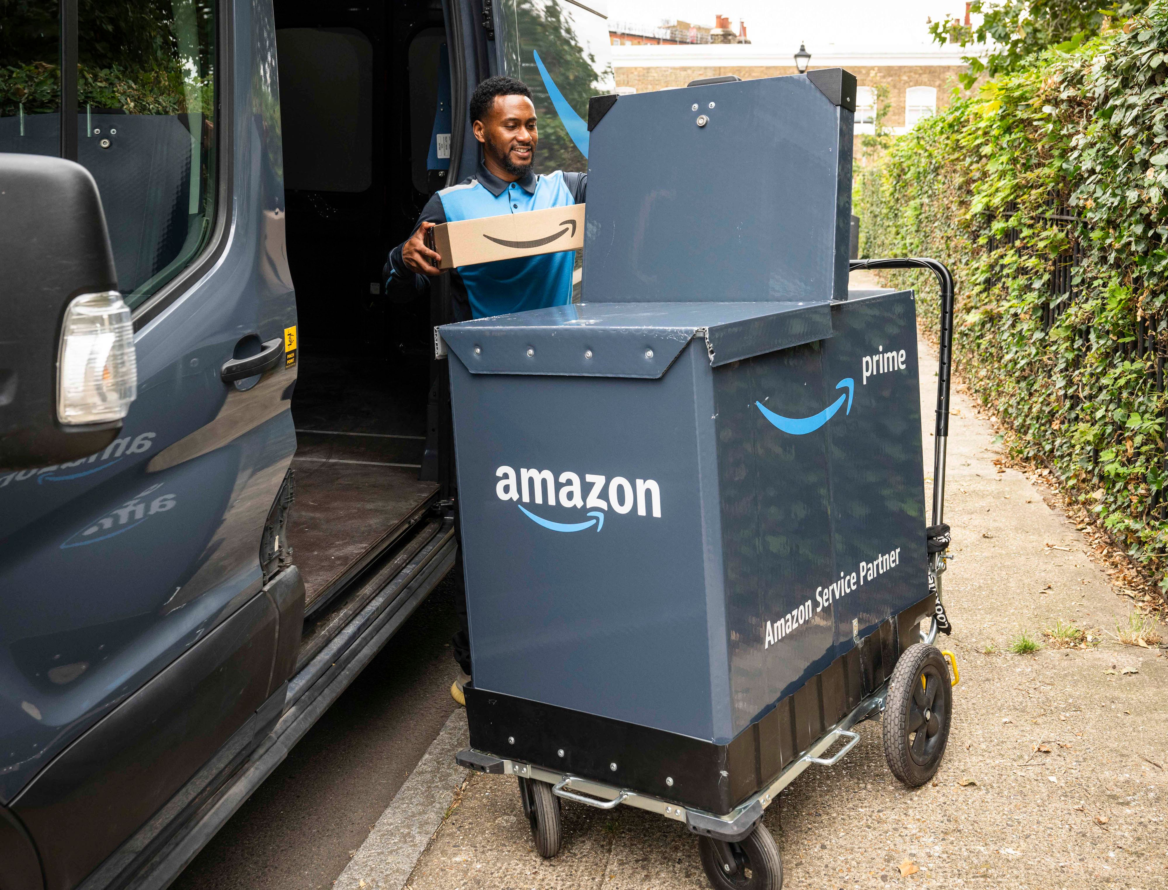 An Amazon worker uses its on-foot trolley