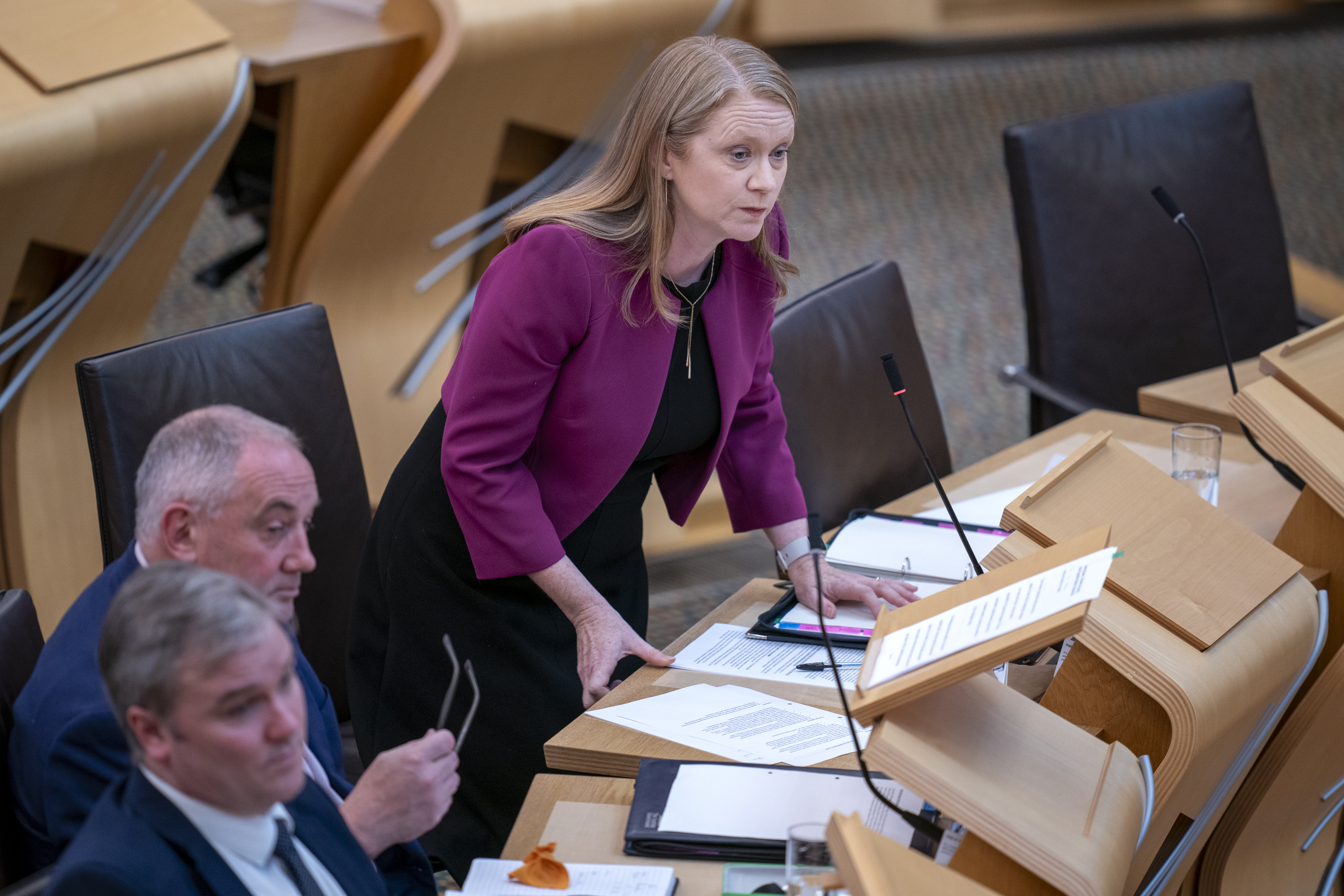 Shirley-Anne Somerville standing while speaking in Parliament