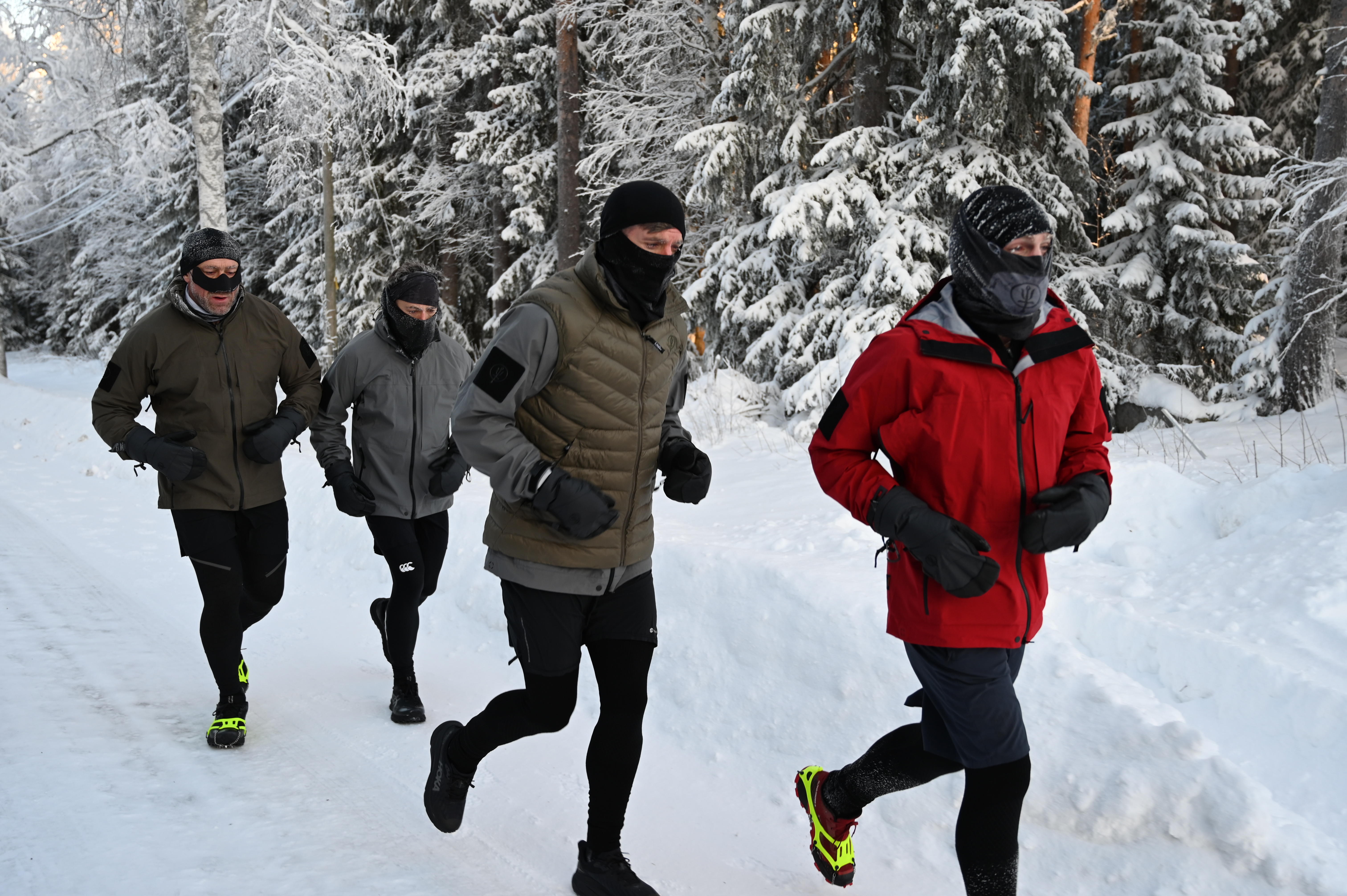 A group of men running in the snow