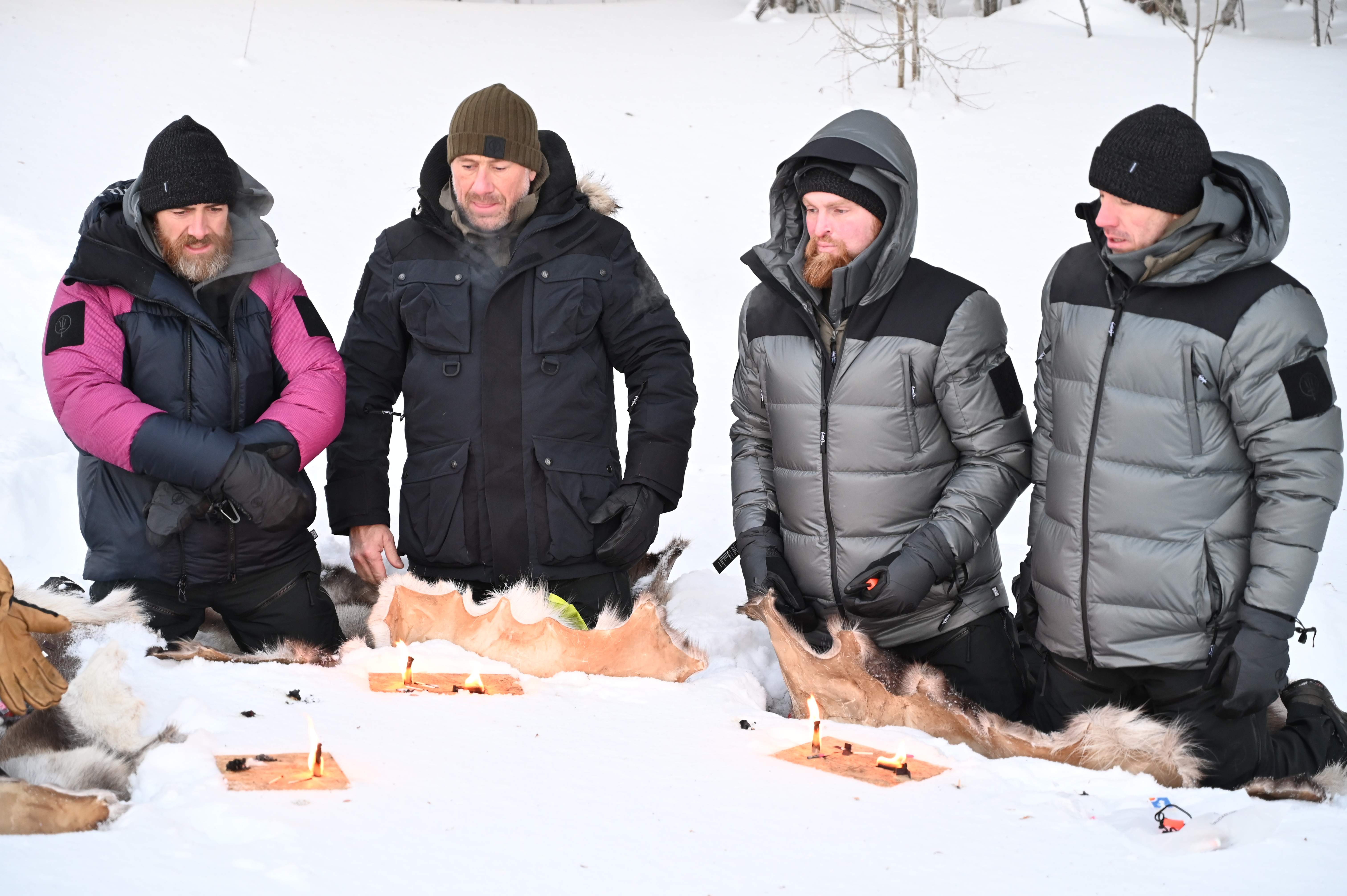 A group of men by a fire