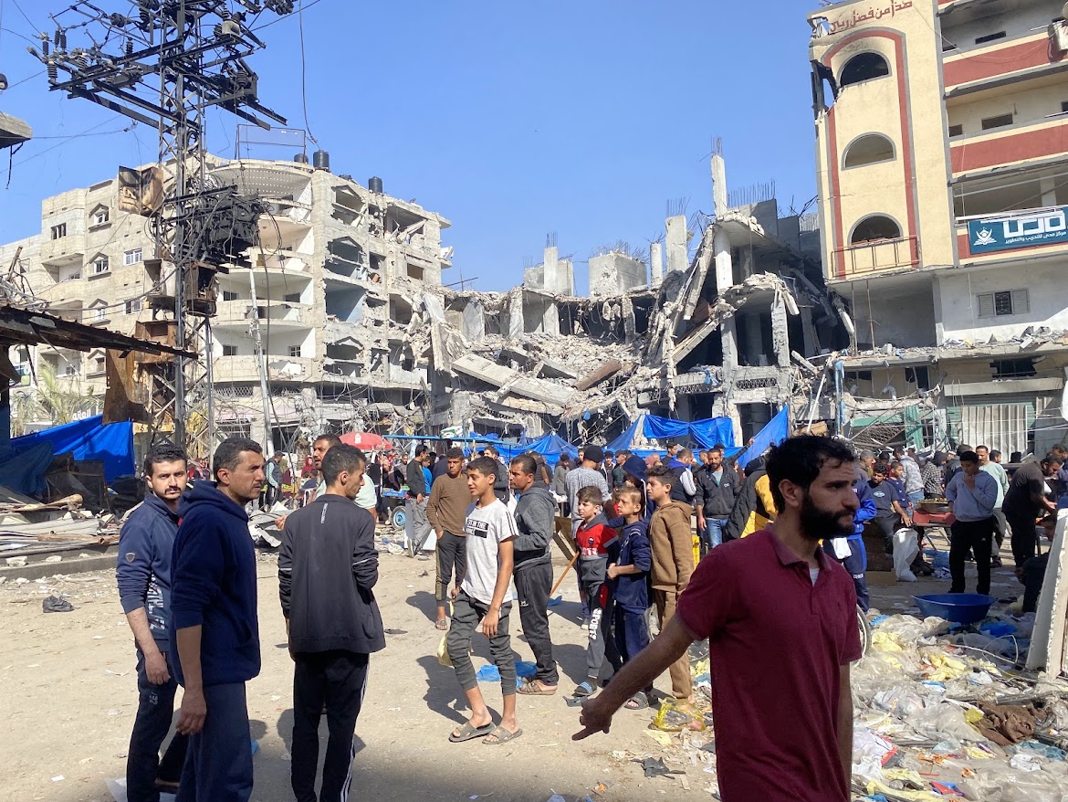 People standing around a toppled building