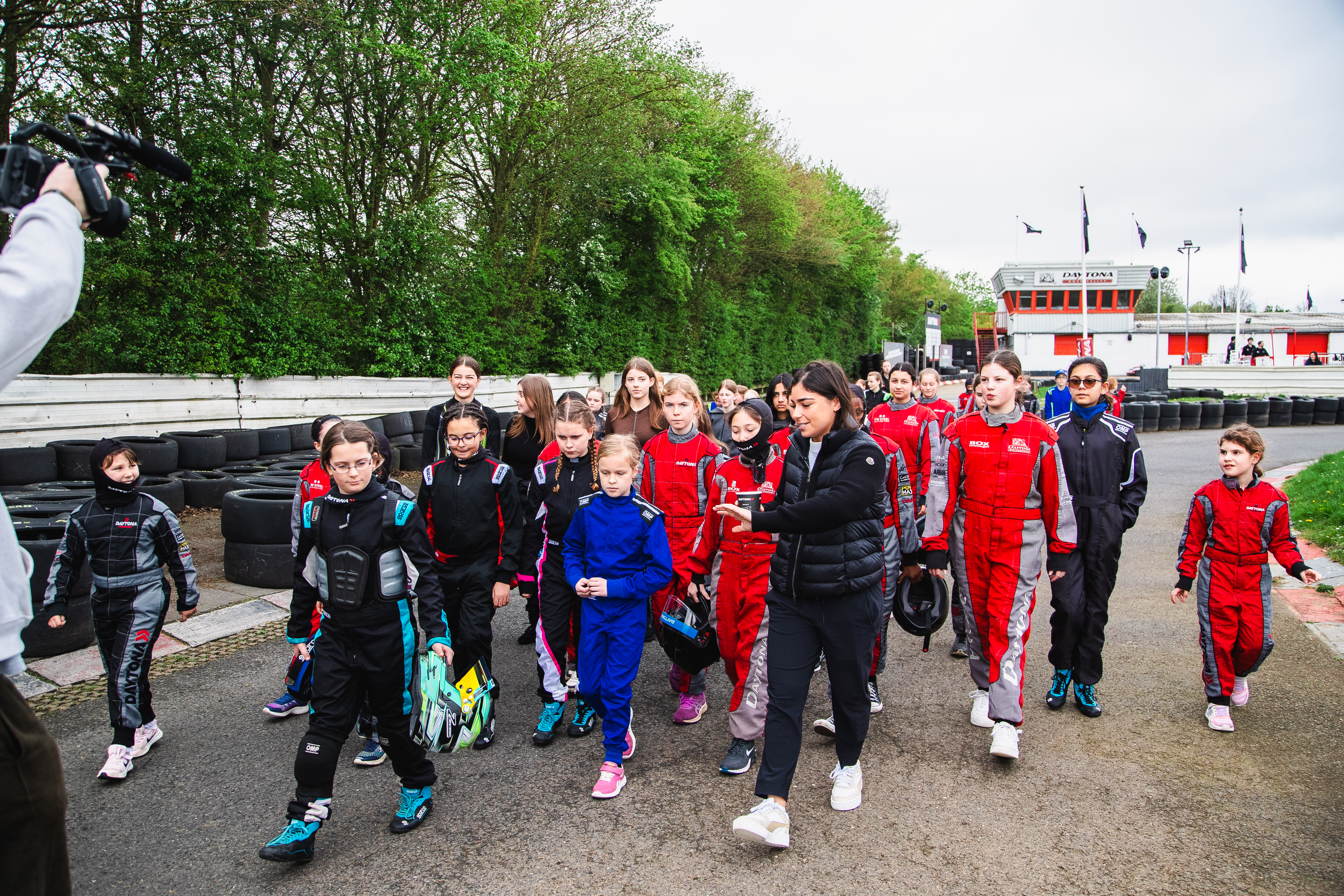 Jamie Chadwick walks with the young female drivers