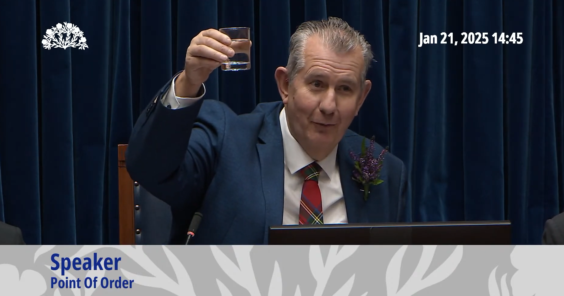 Stormont Speaker Edwin Poots holds up a glass