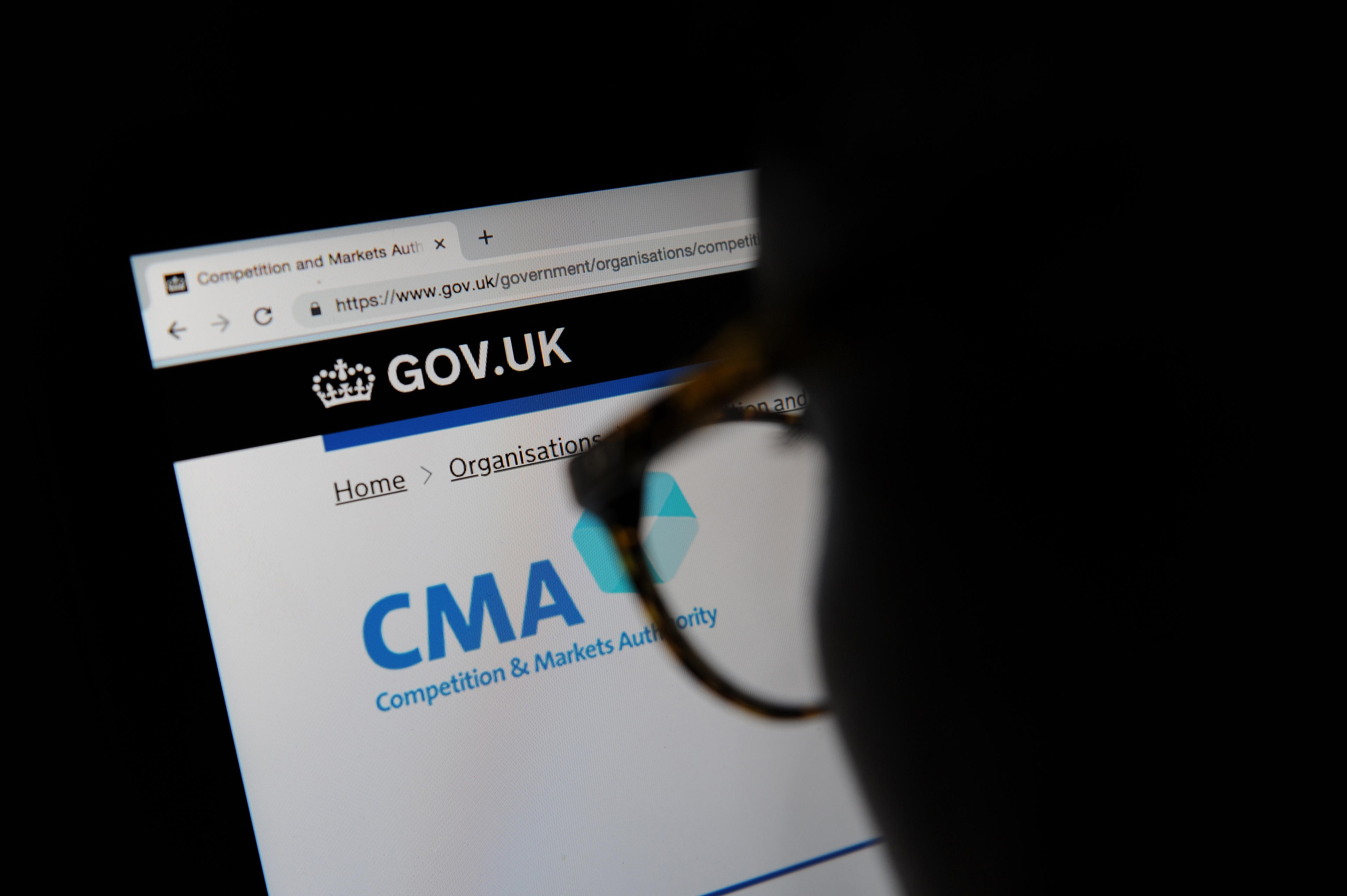 A person looks at the Competition and Markets Authority website