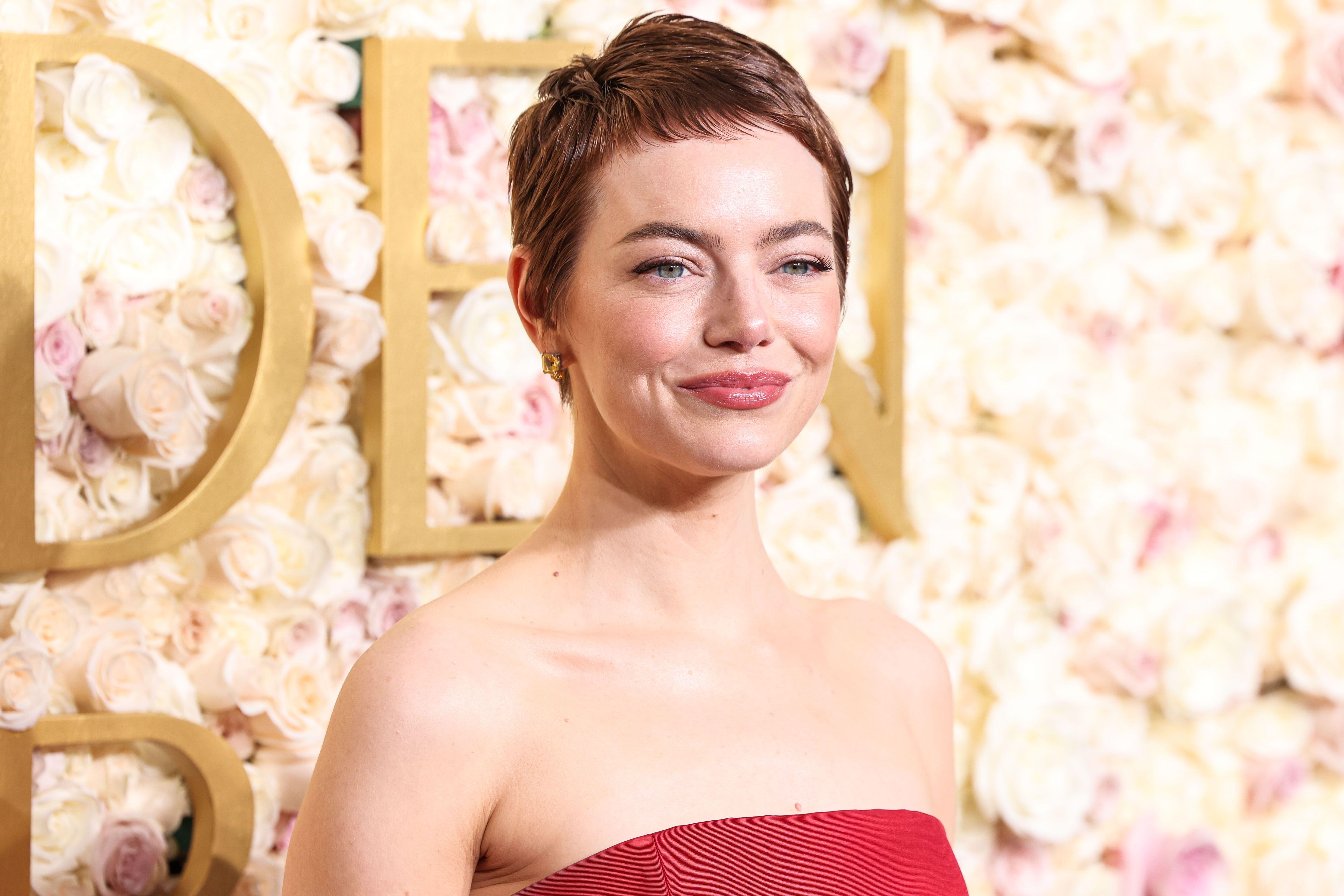 Emma Stone smiles on Golden Globes red carpet