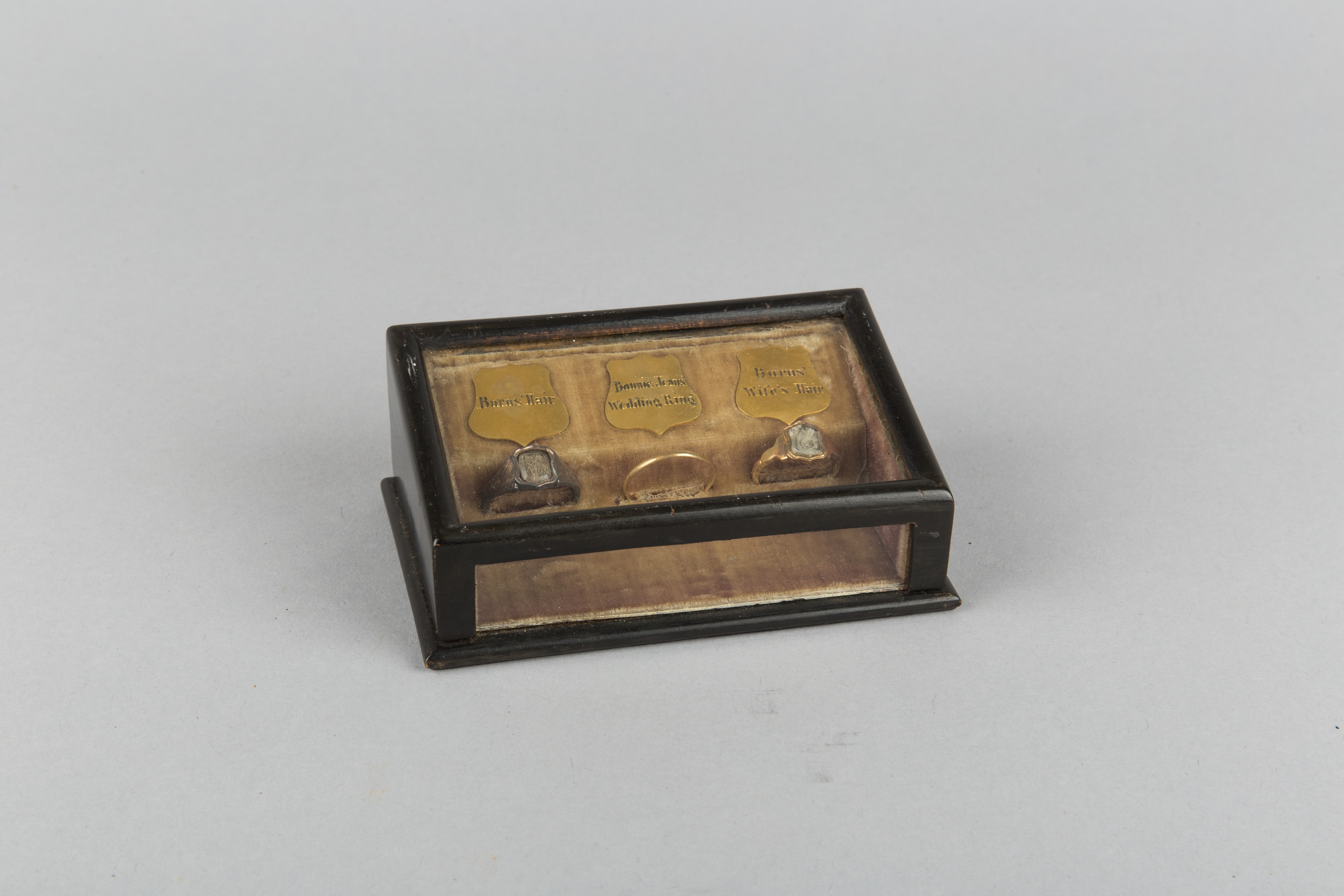 Wooden box containing three rings