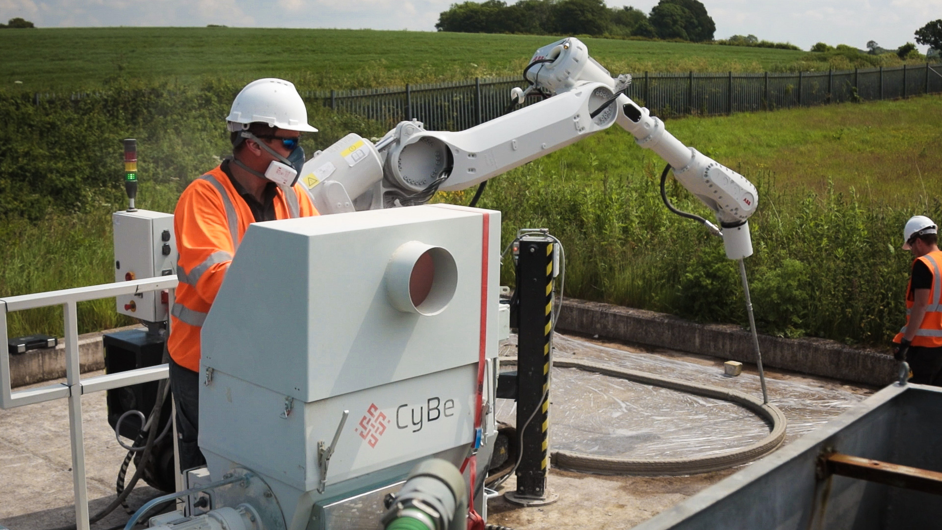 A 3D concrete printing robot being manned at a test facility