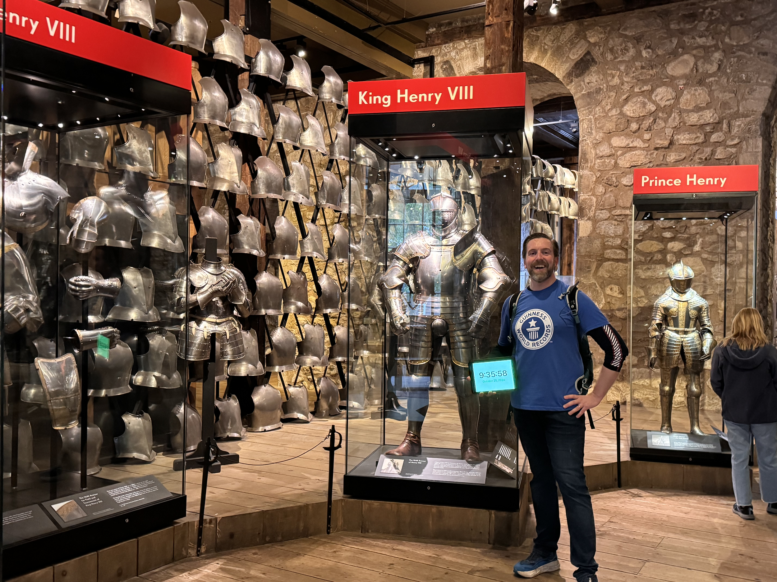 Ben Melham in front of a display showing suits of armour