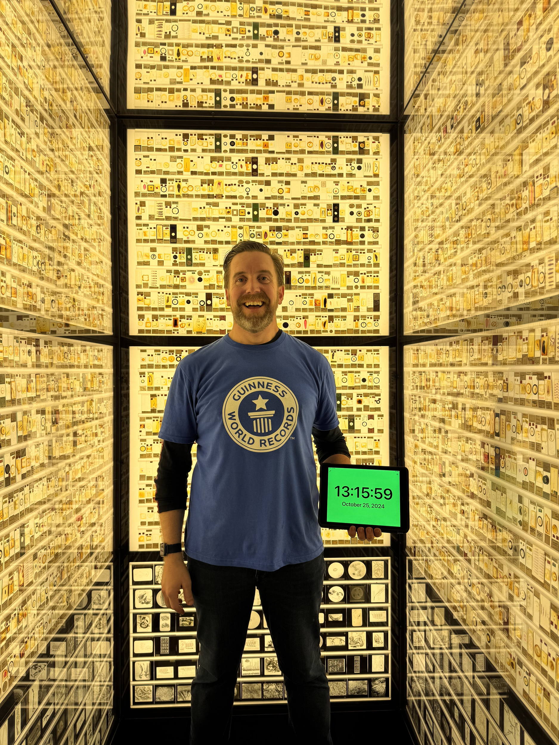 Ben Melham smiling while inside a museum exhibit