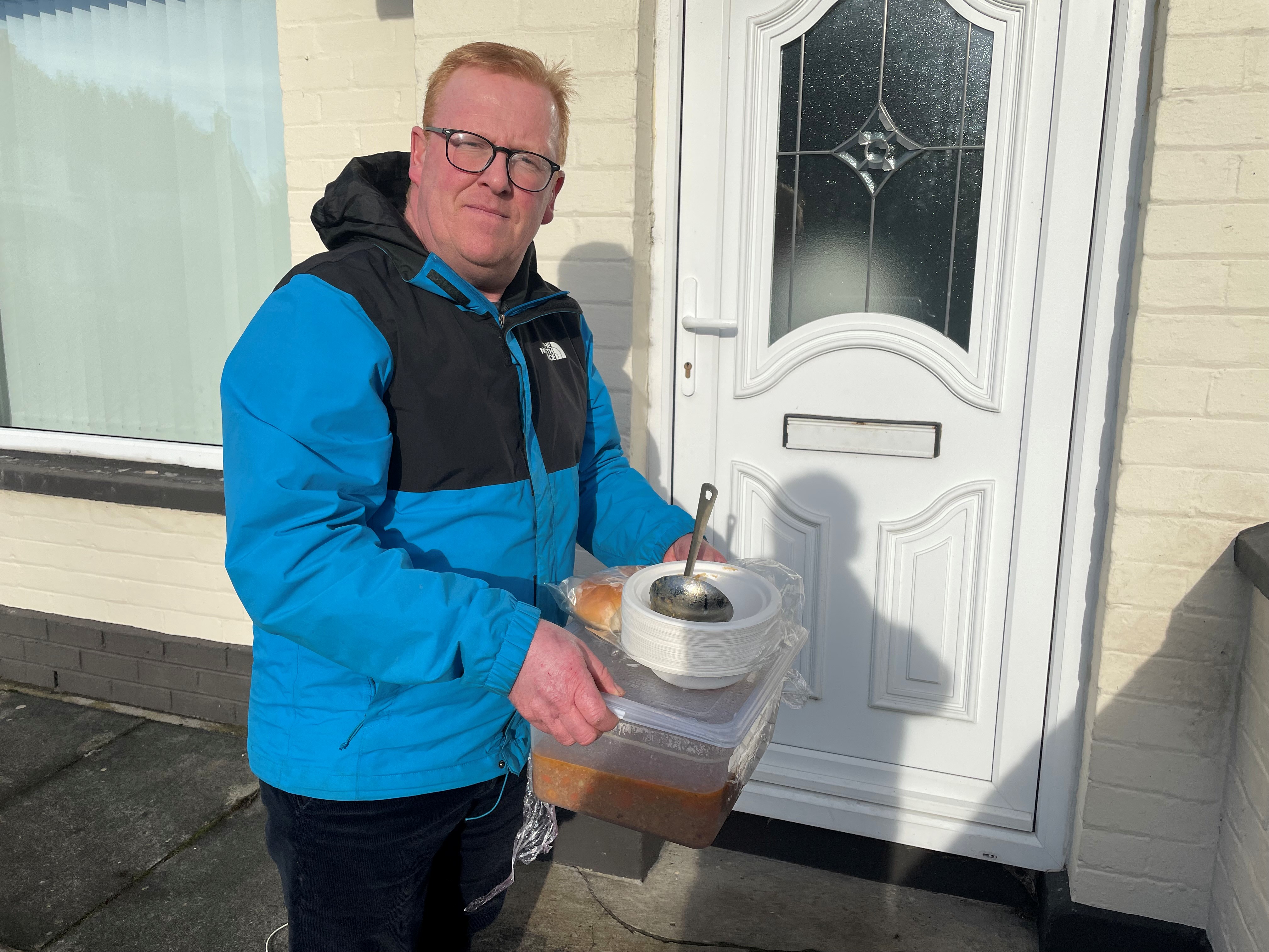 Alan Martin holding container of hot food