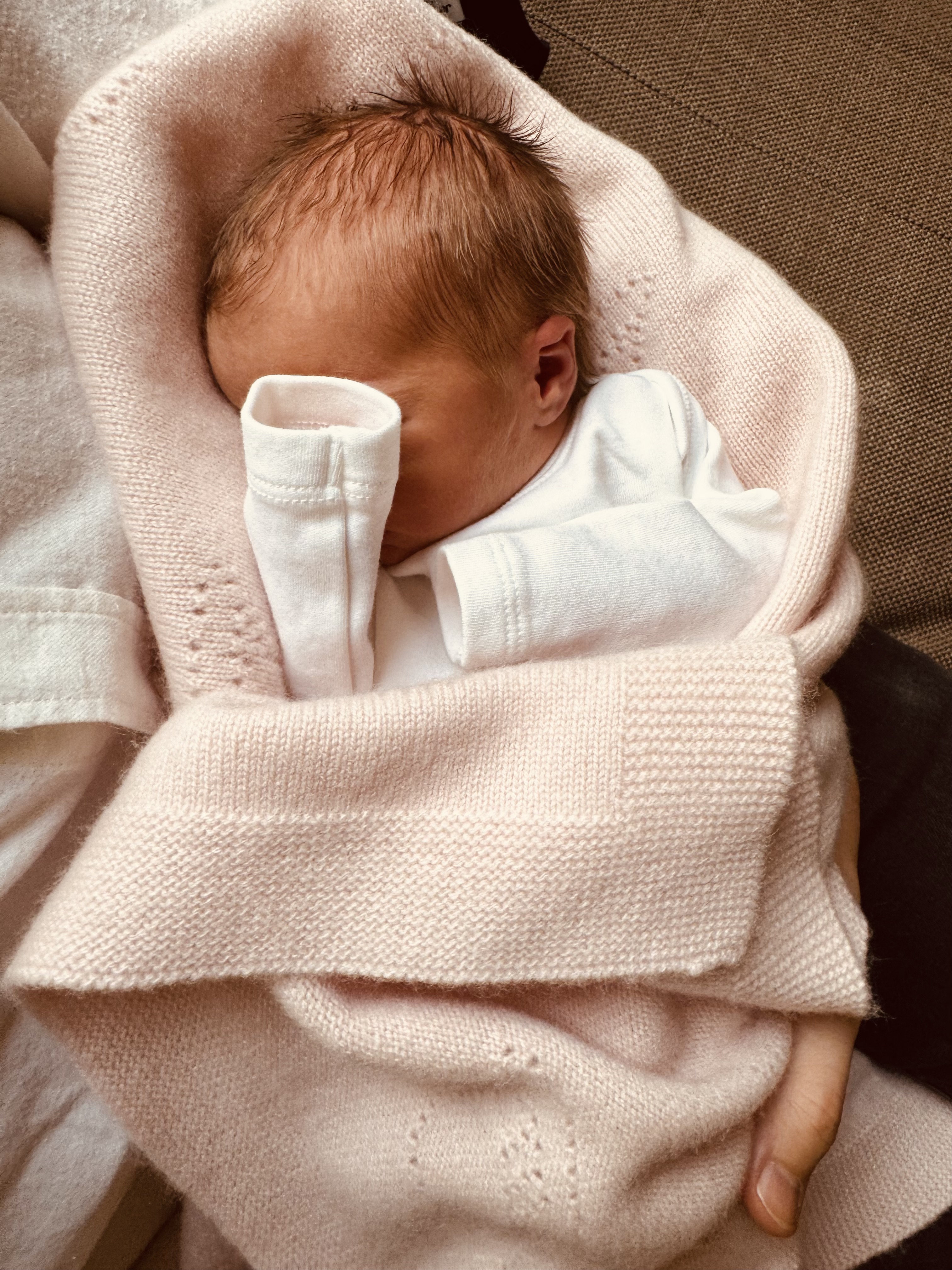 Baby Athena Elizabeth Rose Mapelli Mozzi wrapped in a pink blanket