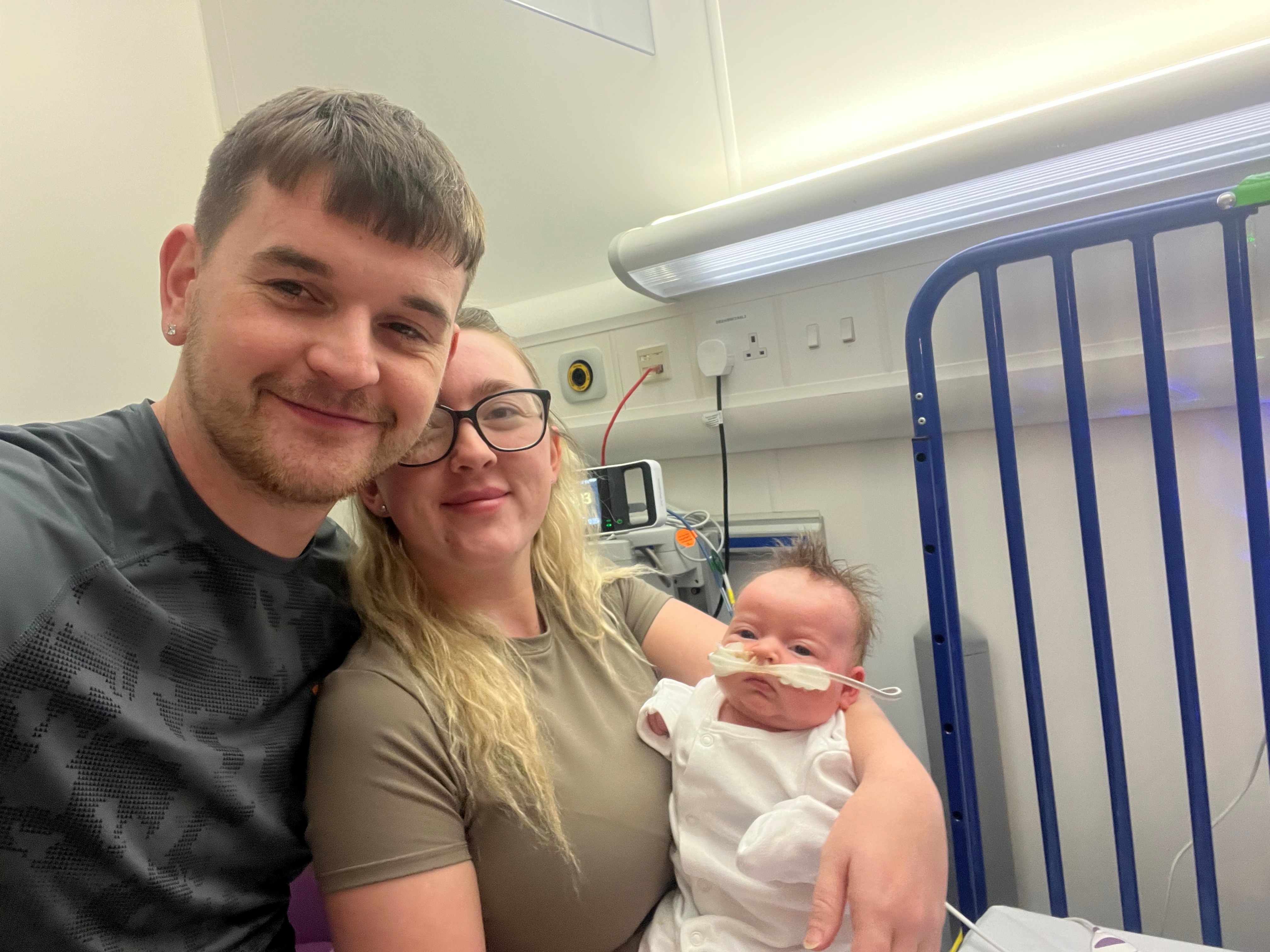 Dolcie-Mae with her parents Courtney-Jade Edwards and Ashley Raymond in hospital