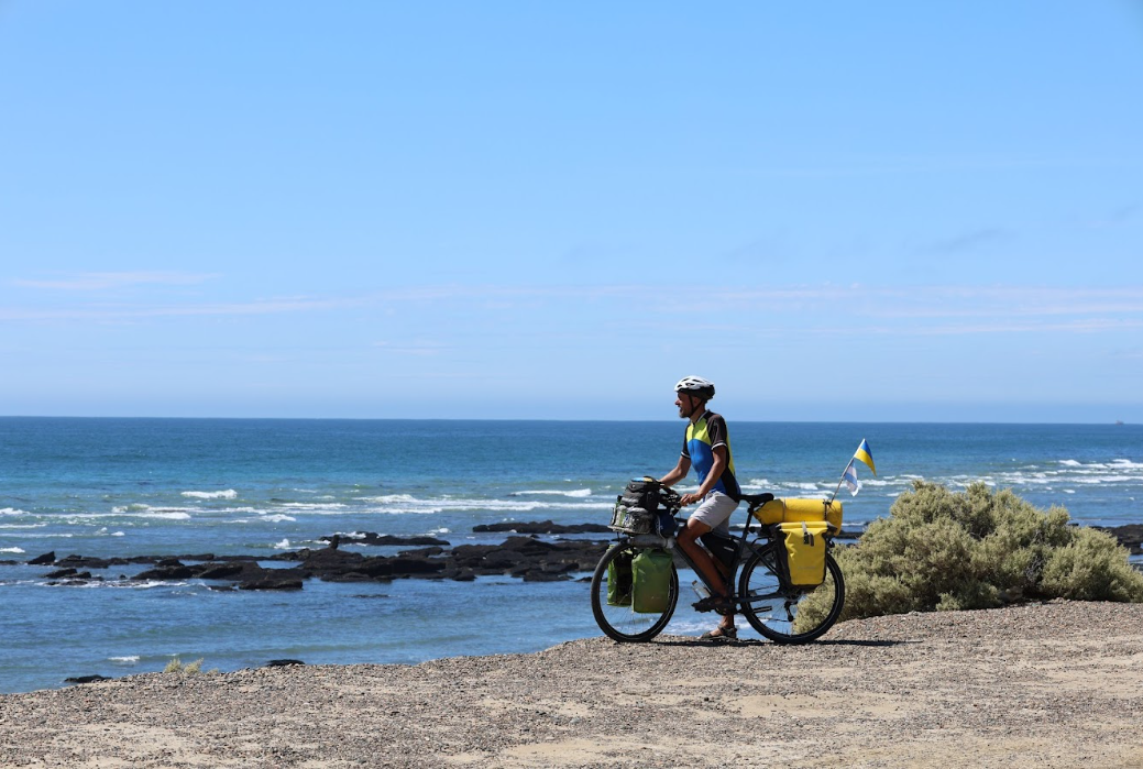 Volodymyr Muliar pictured cycling near a beach 