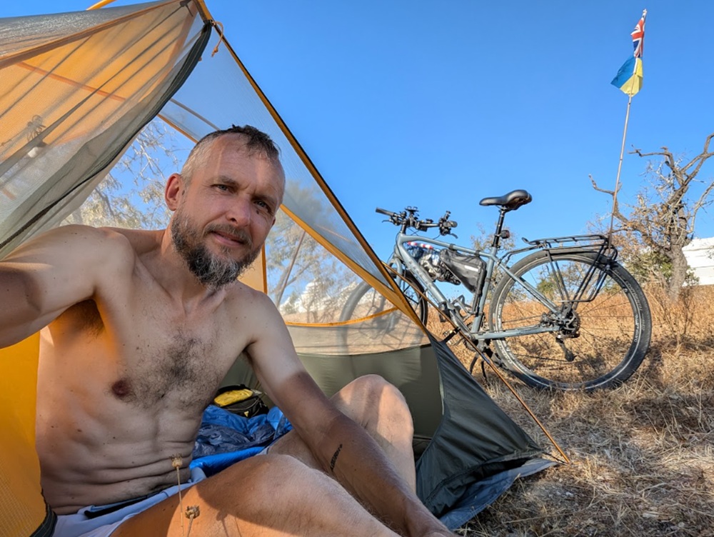 Volodymyr Muliar pictured in a tent during a global cycling challenge