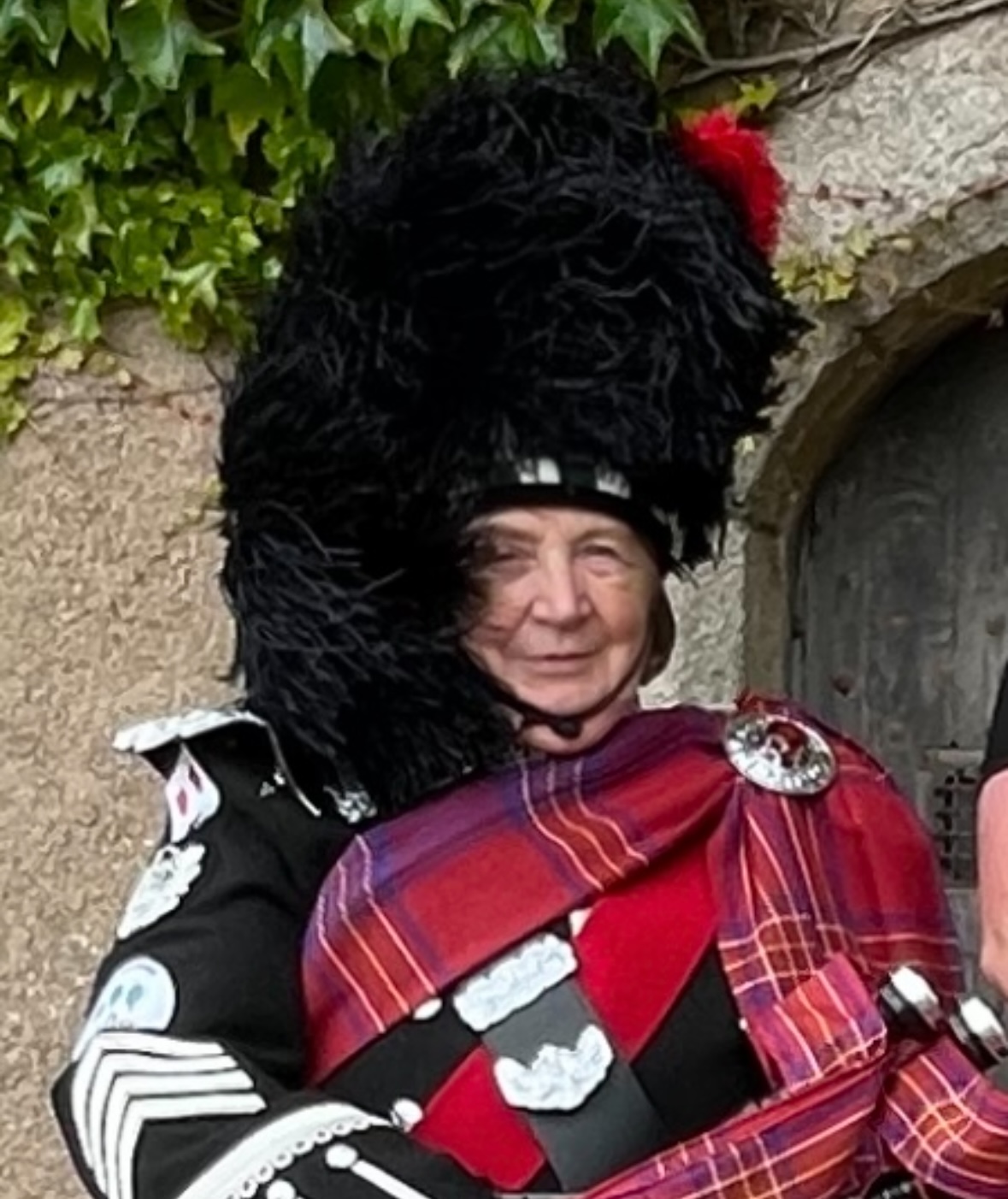 Lady Jane Macrae smiling while dressed in full tartan regalia