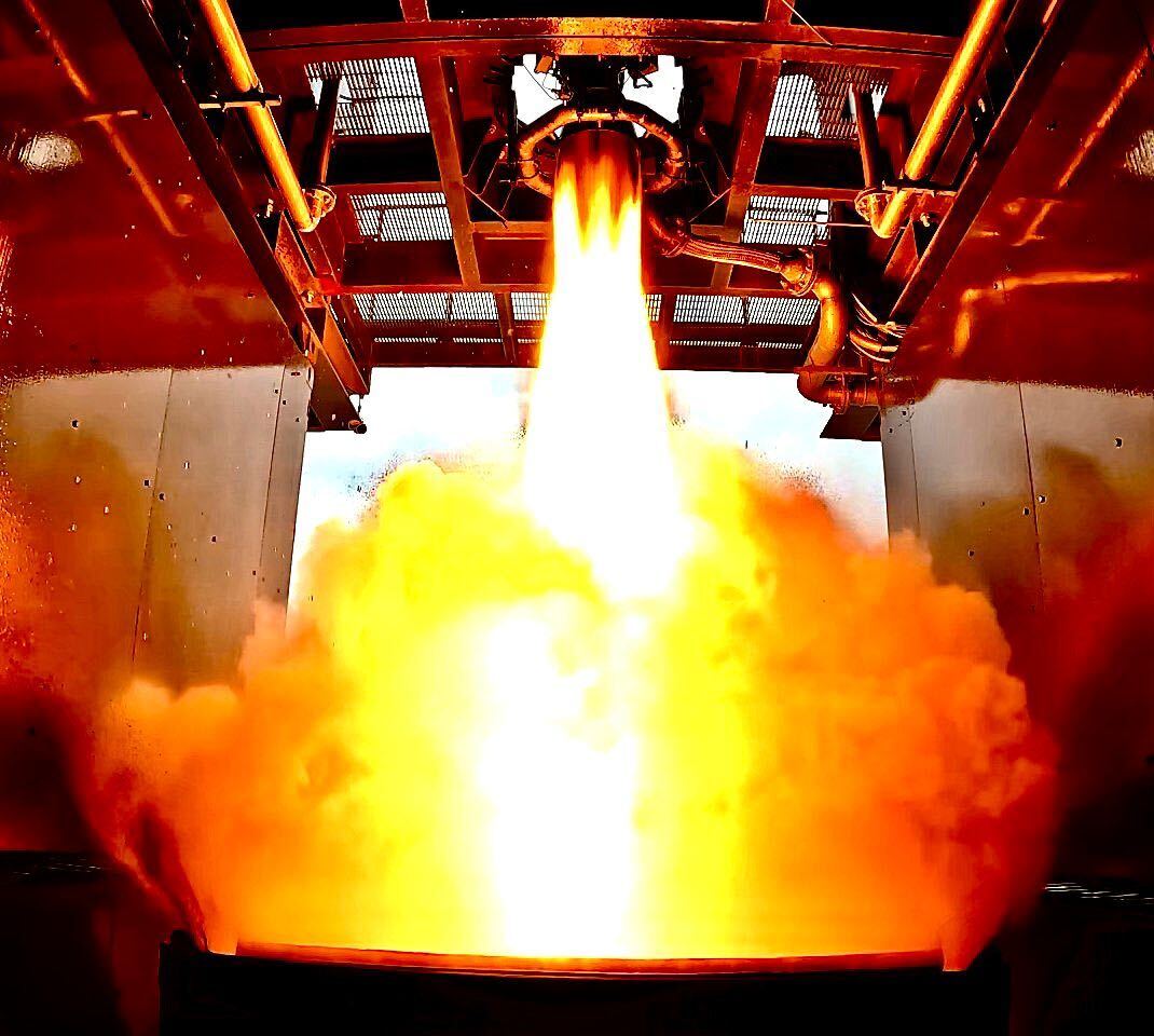 Large plume of smoke and fire beneath a rocket engine