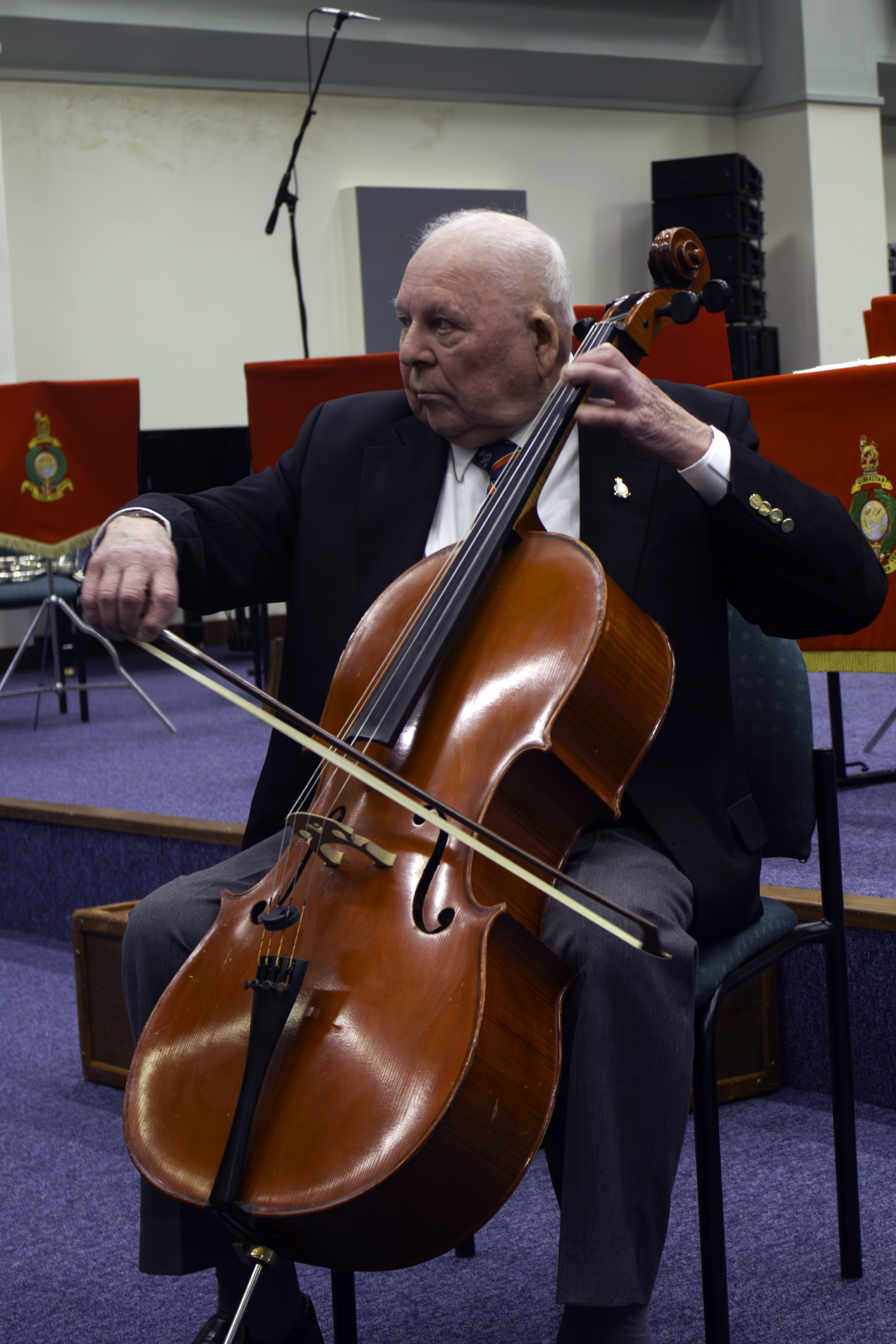 Mr Latham shows the Royal Marine musicians his cello skills (Ministry of Defence/Crown Copyright/PA)