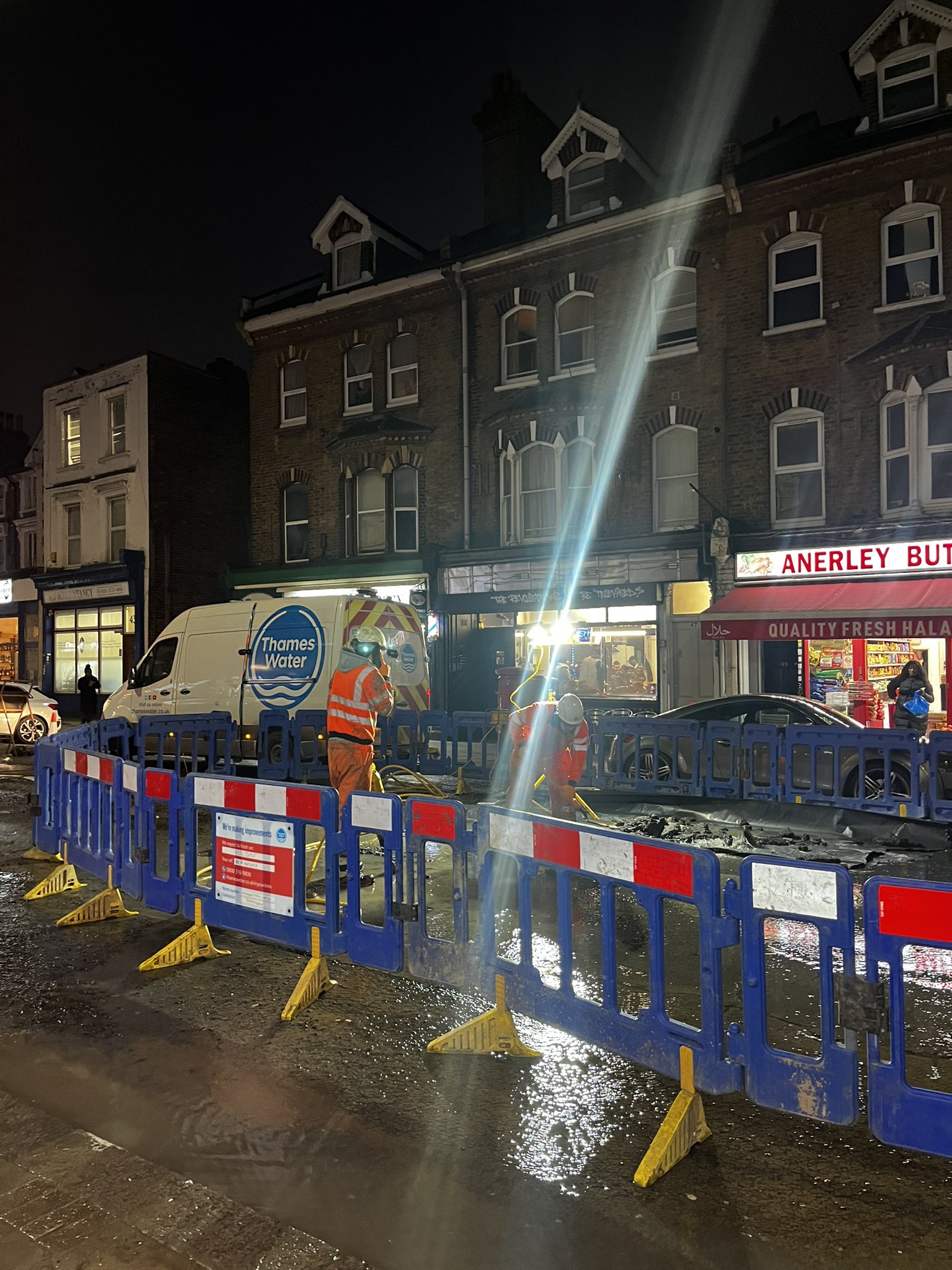 Workmen cordon off part of a road 