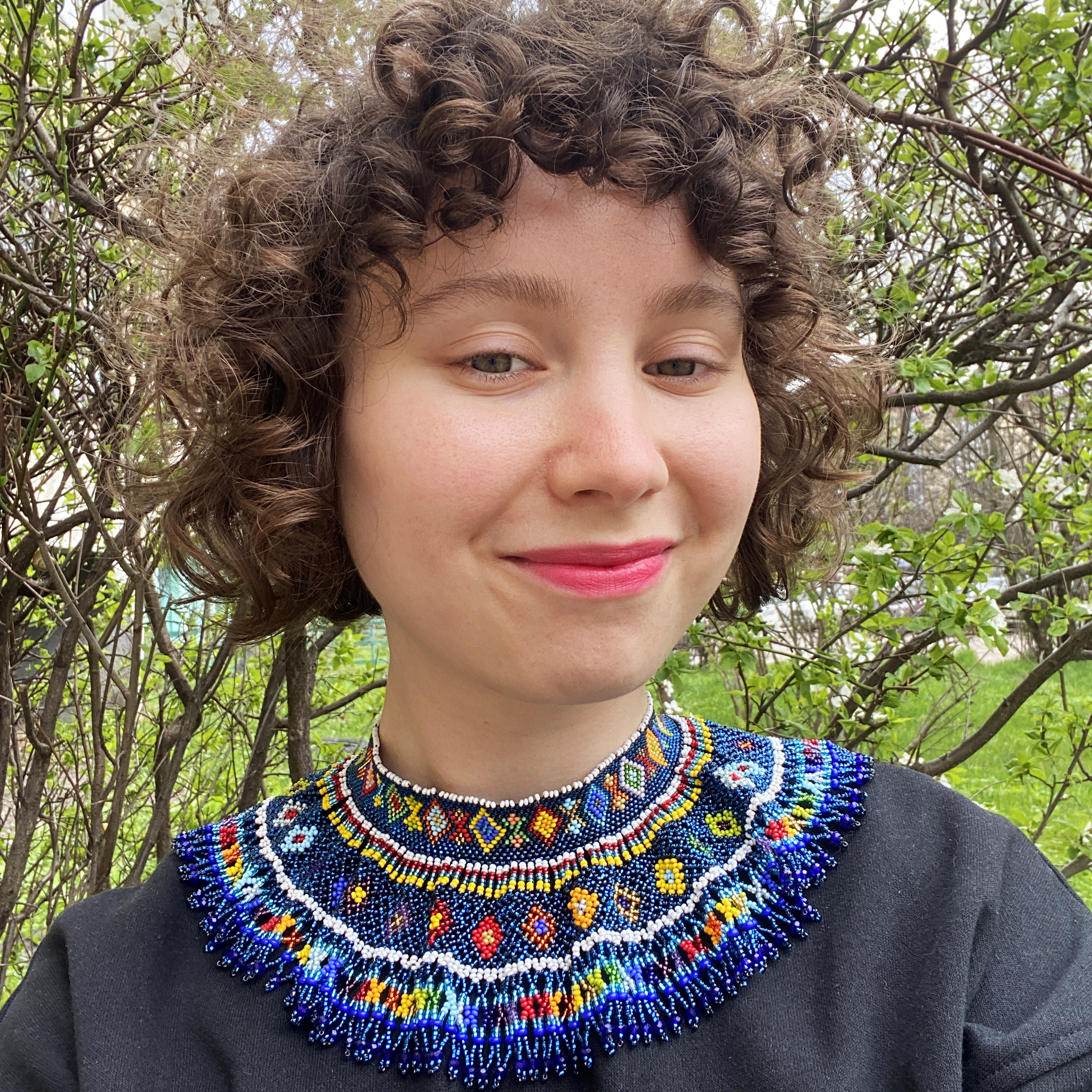 A Ukrainian woman wearing tradition Ukrainian clothes taking a selfie