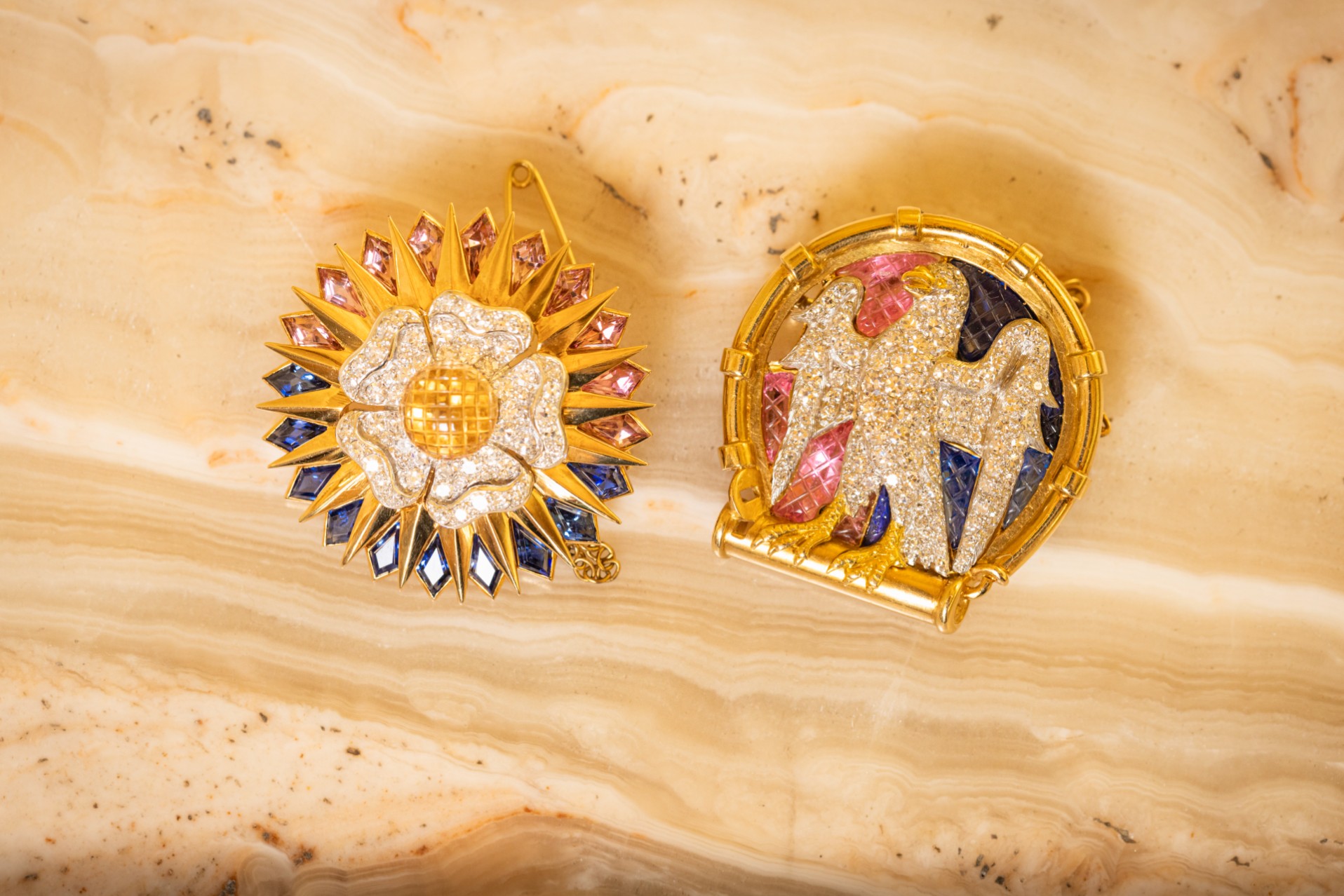 The brooches depict a falcon and a white Tudor rose