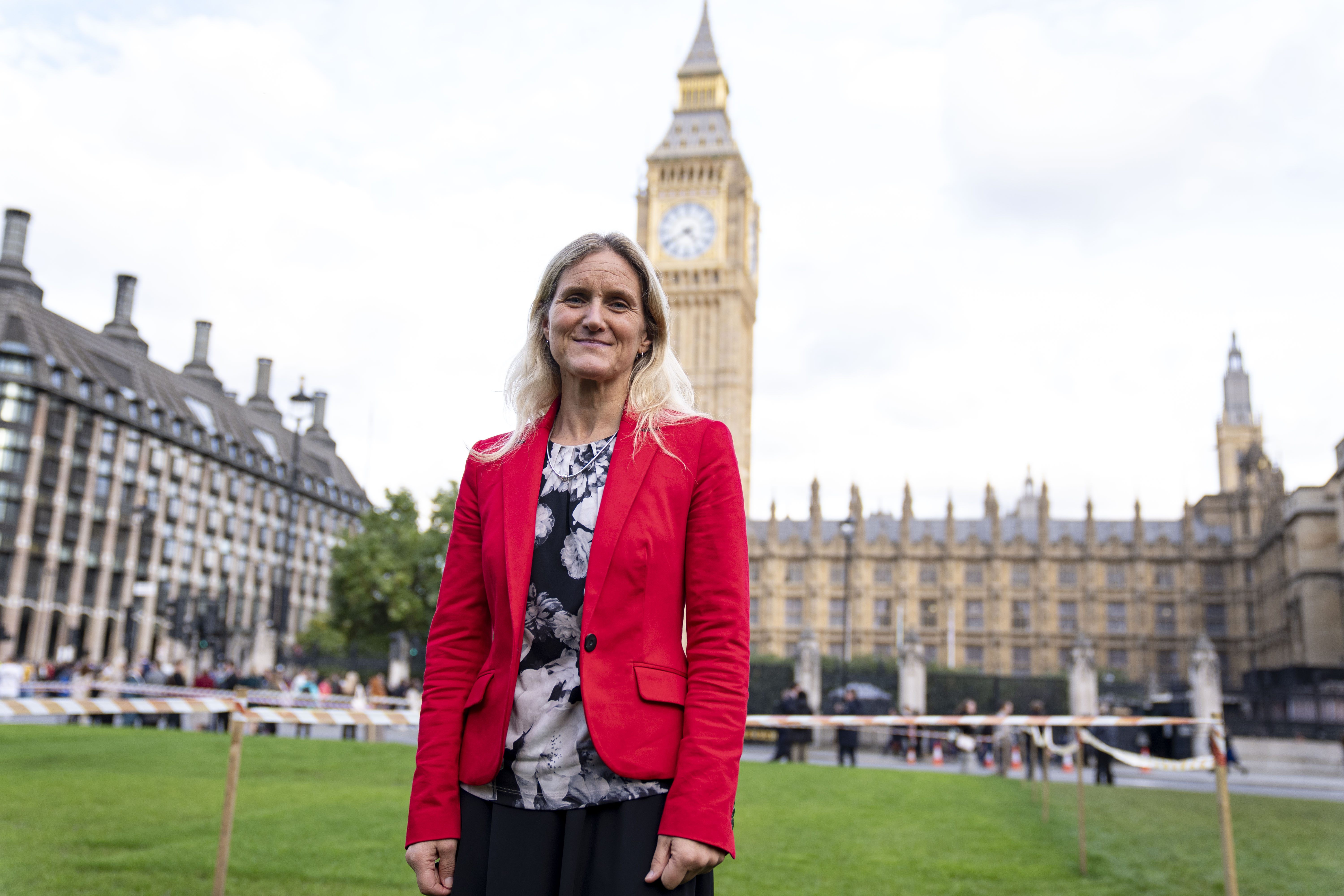 Kim Leadbeater smiling in front of the Houses of Parliament