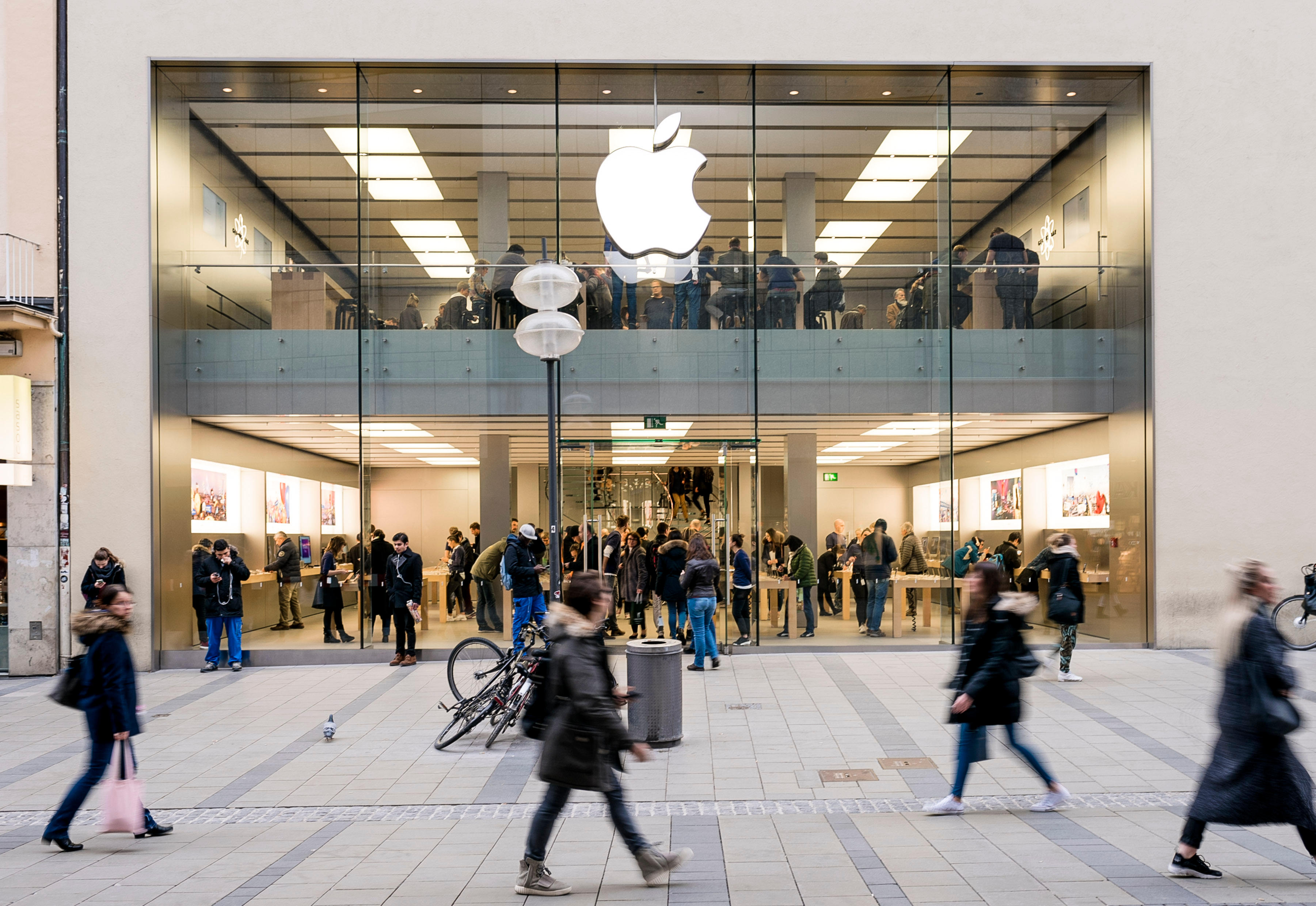 An Apple store exterior with people walking past