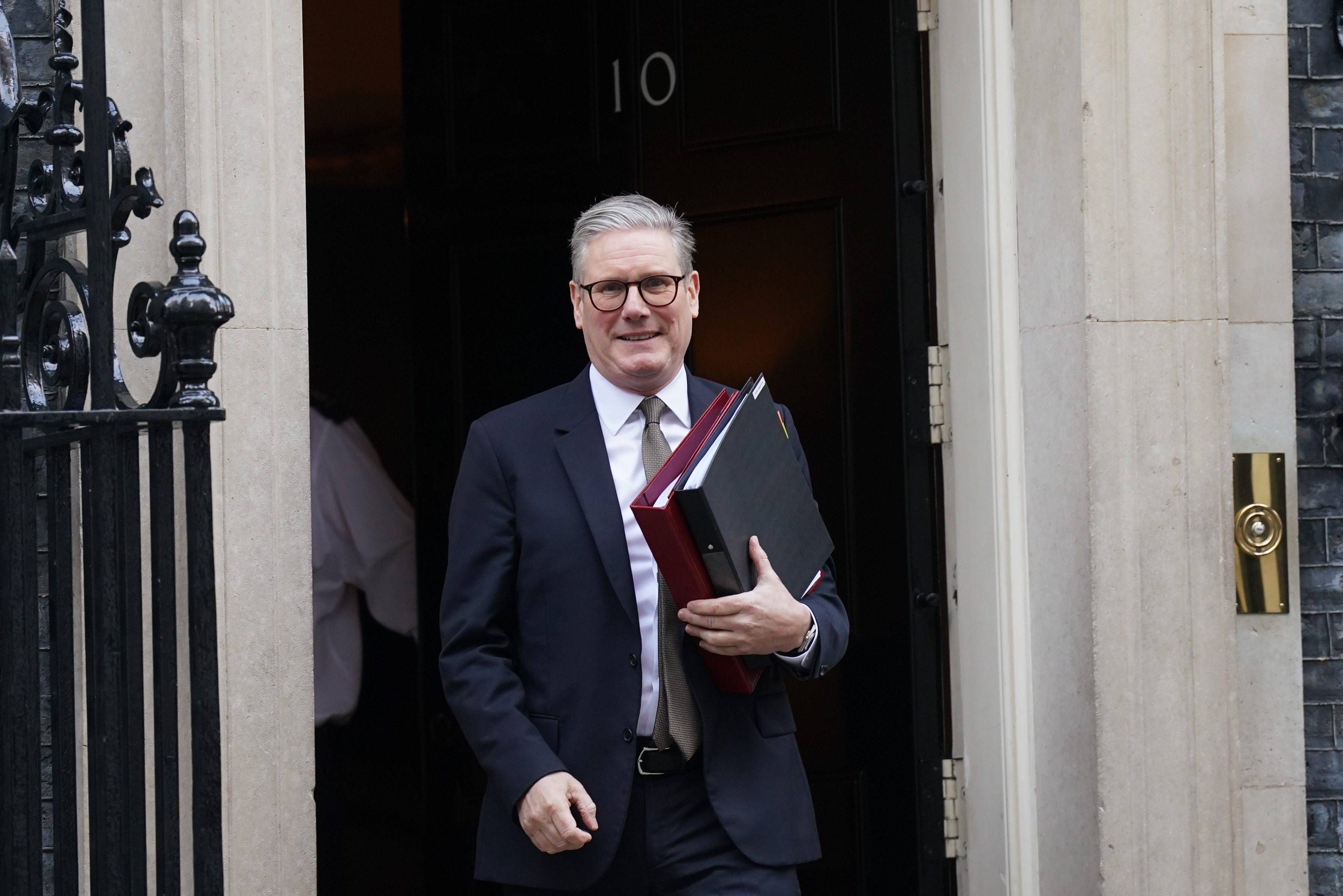 Sir Keir Starmer smiling as he leaves 10 Downing Street