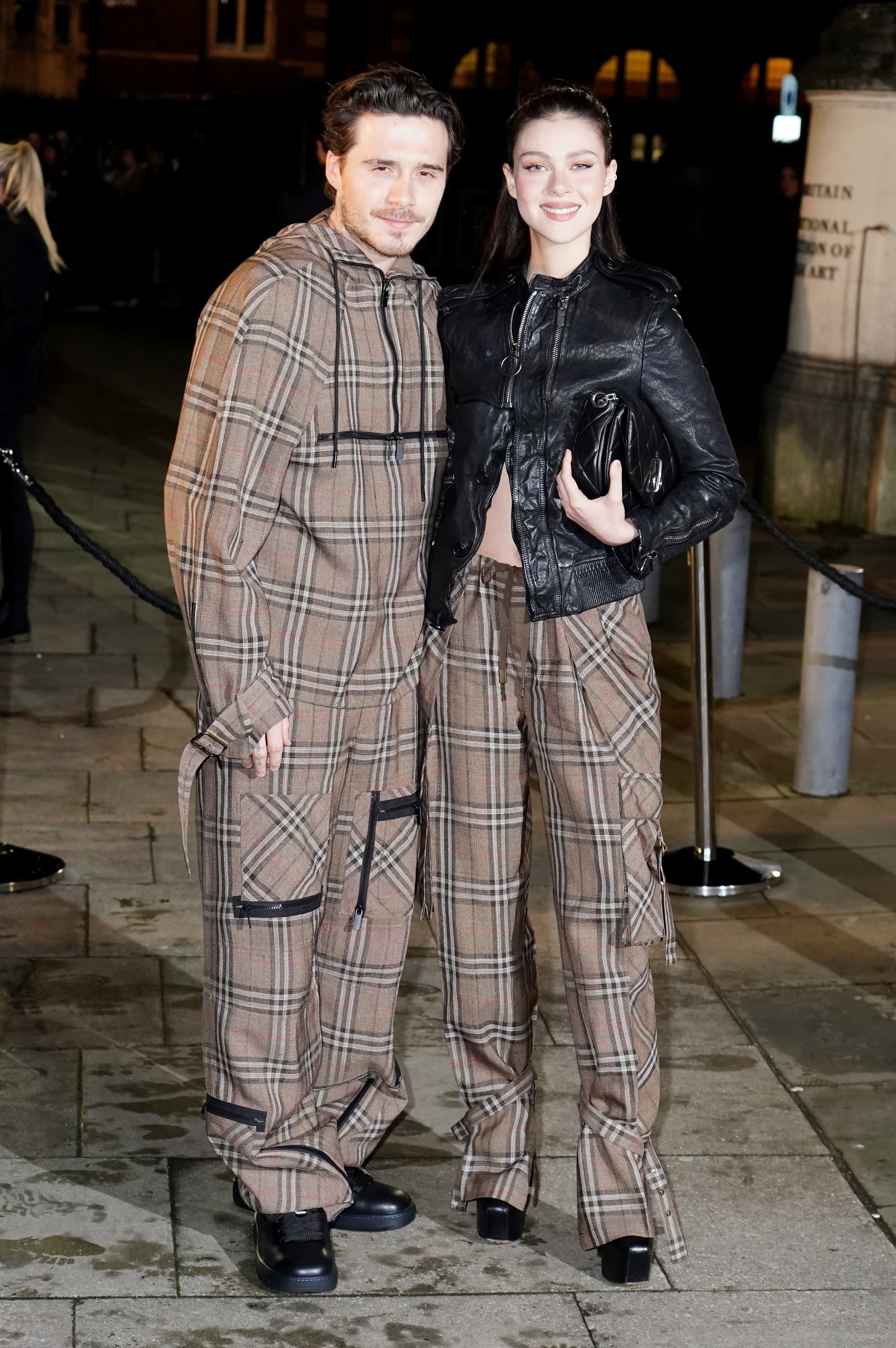 Brooklyn Beckham (left) and Nicola Peltz arriving at the Burberry show at Tate Britain, London, during London Fashion Week. 