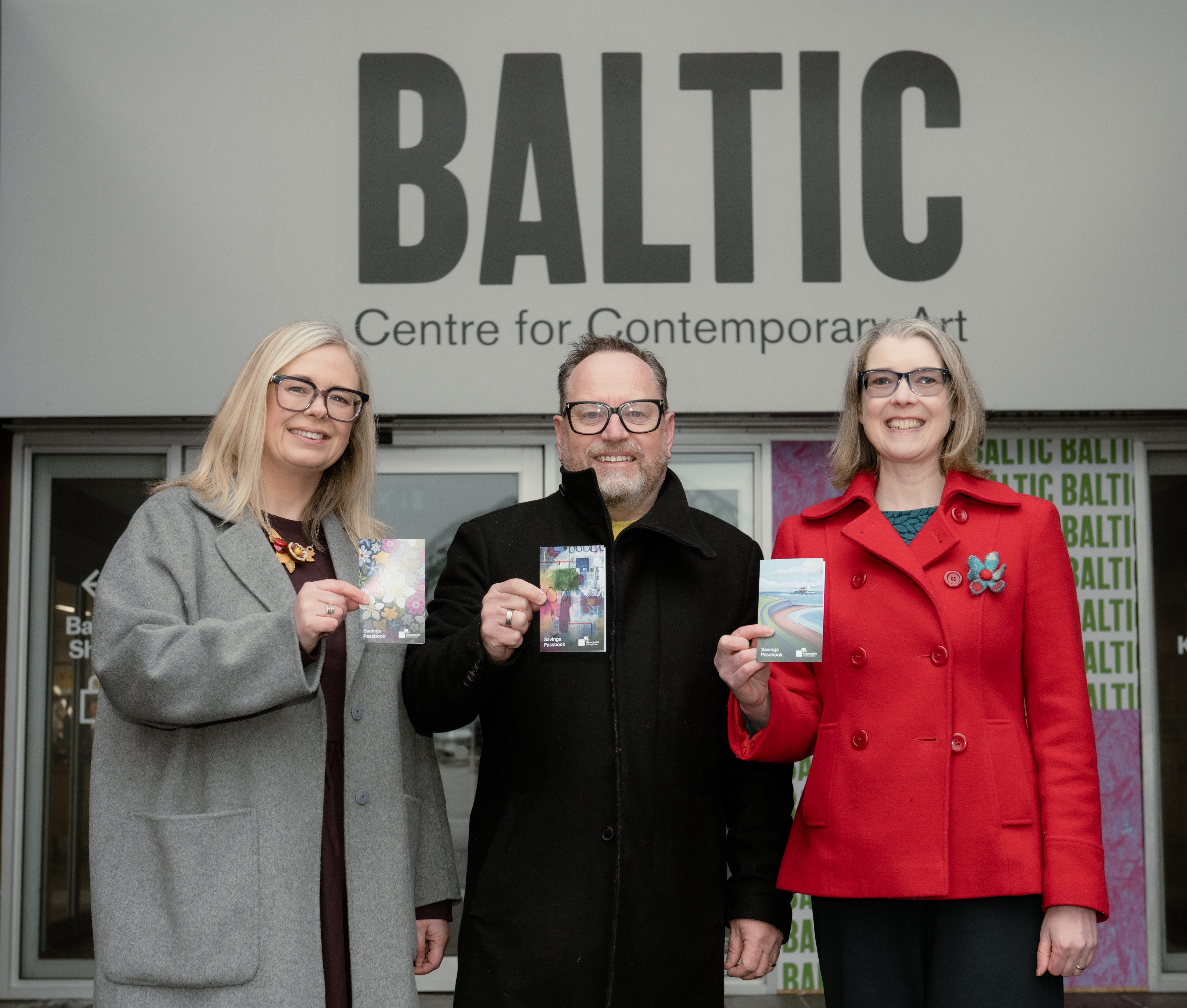 Artists holding up passbooks