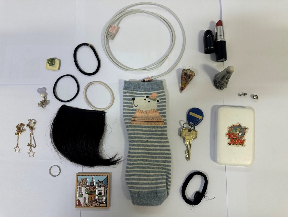 Various items including hairbainds, a sock and a phone charging cable