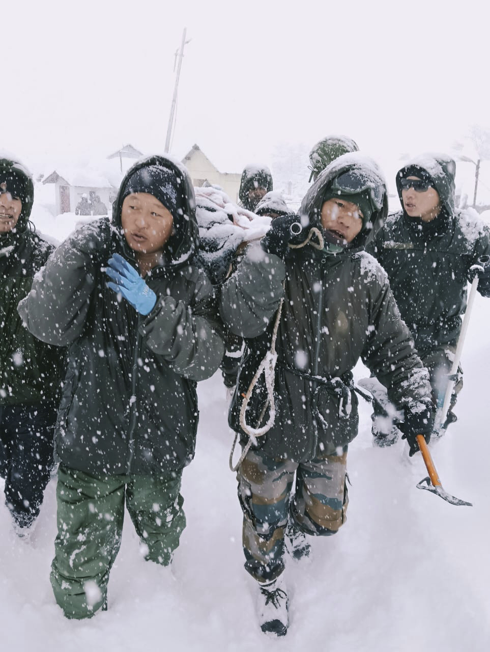 A rescue team in heavy snow