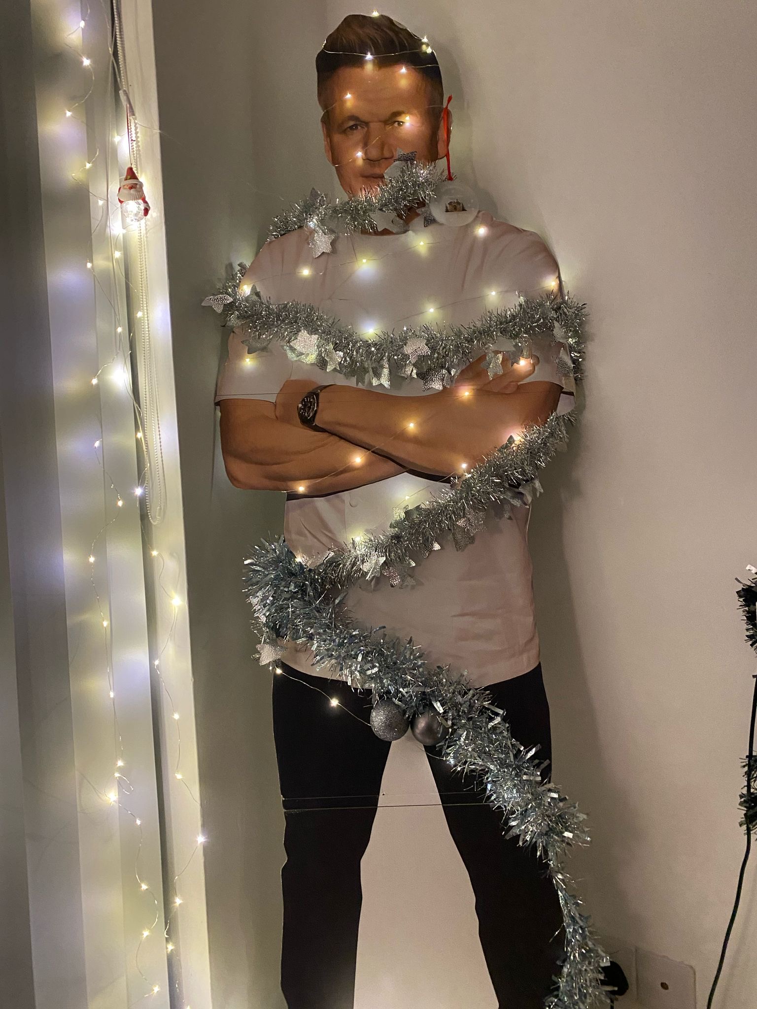 A Gordon Ramsay cardboard cutout with decorations on it