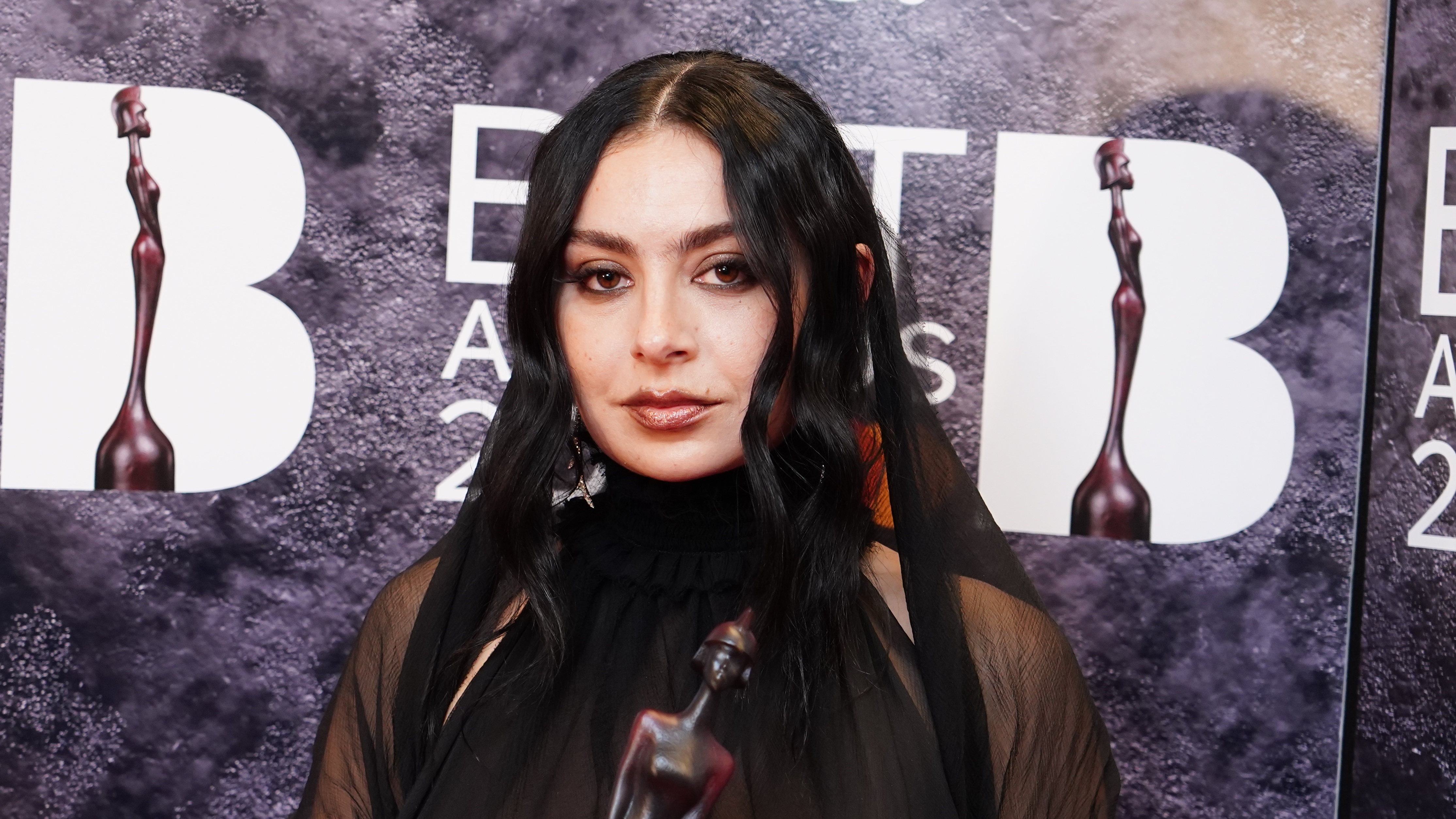 Charli XCX backstage at the Brit Awards at London's O2 Arena after she won in five categories 