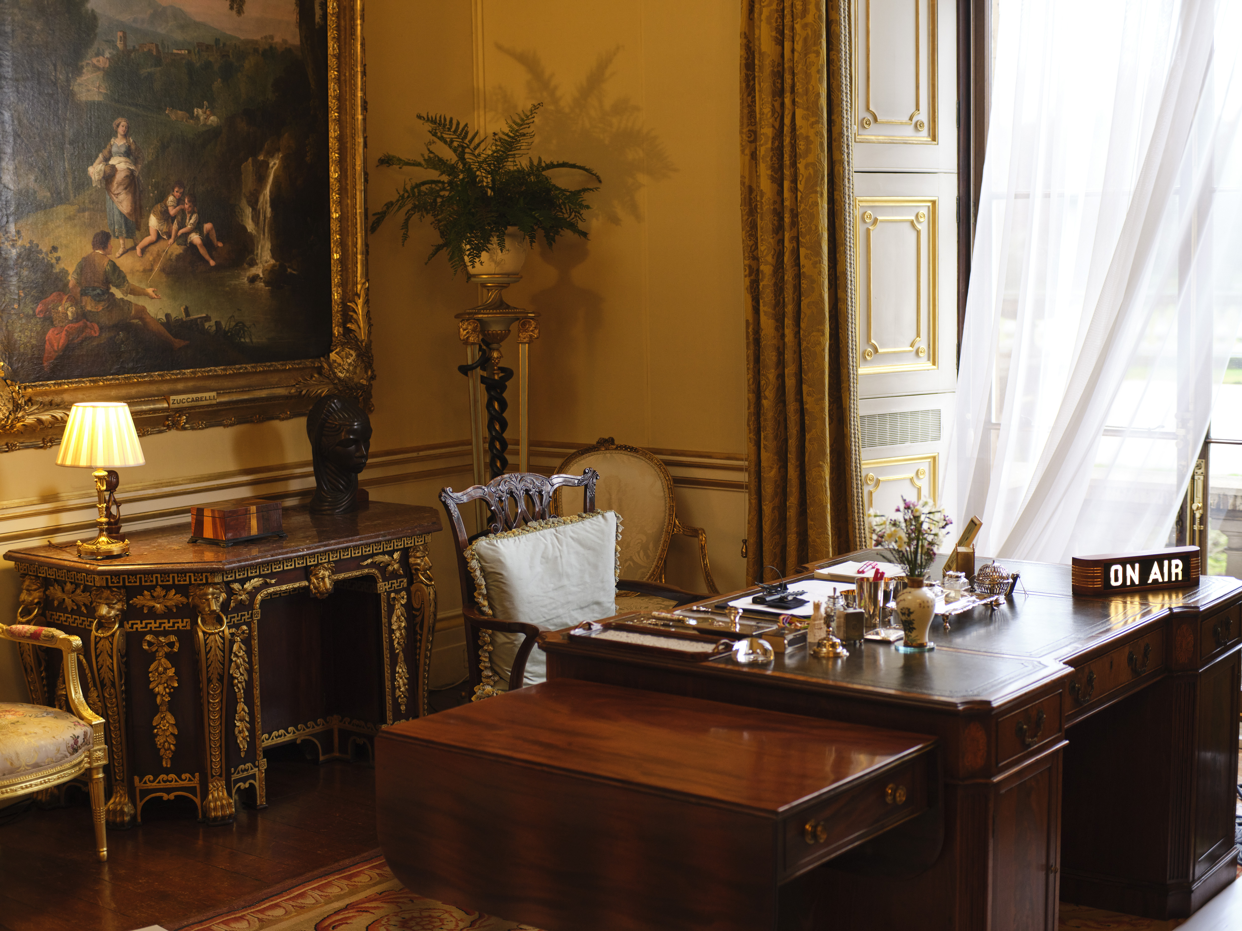 The King's empty desk in his office at Buckingham Palace with an illuminated vintage On Air sign in place