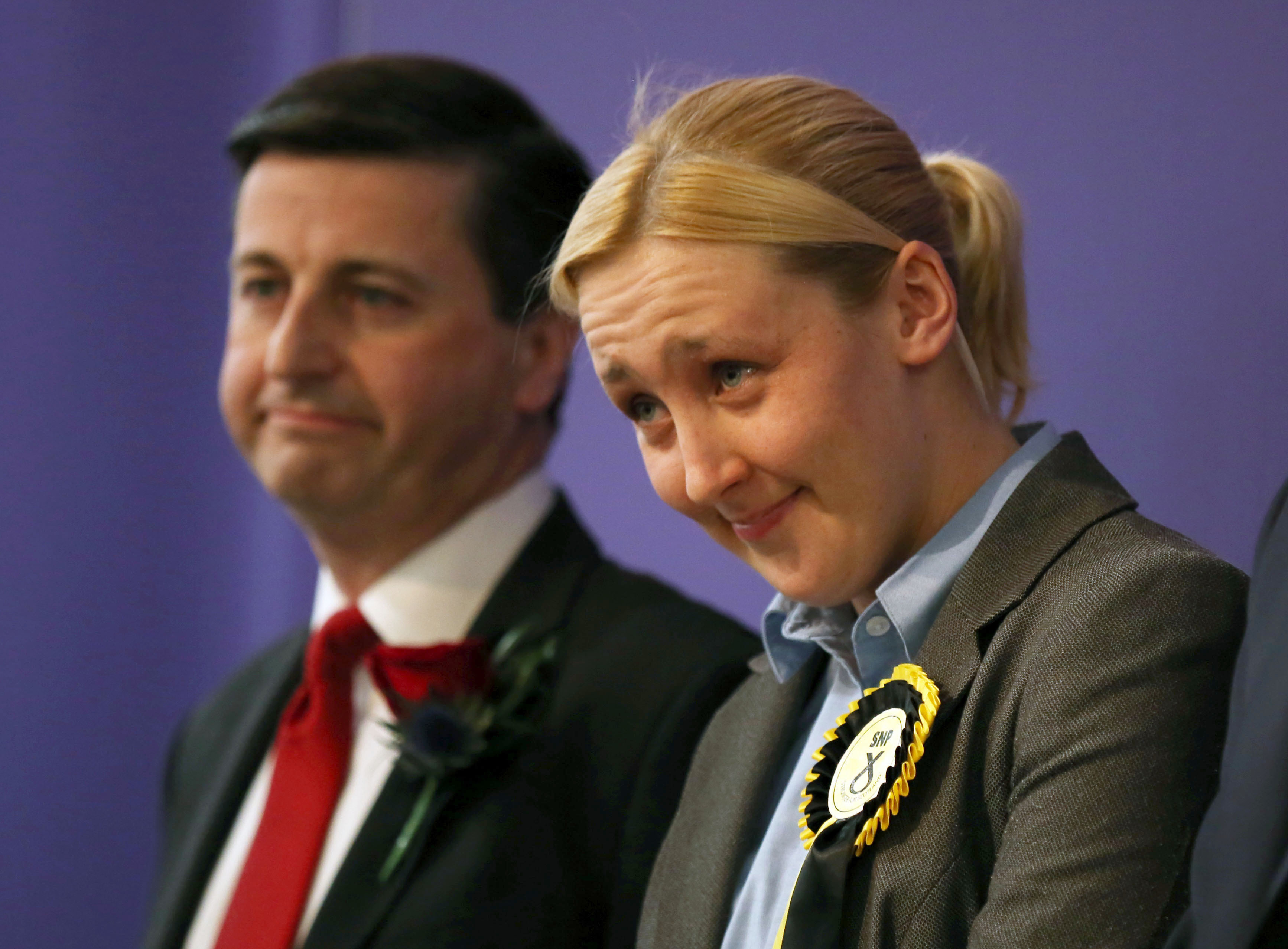 Mhairi Black smiling with head bowed, with Douglas Alexander beside her