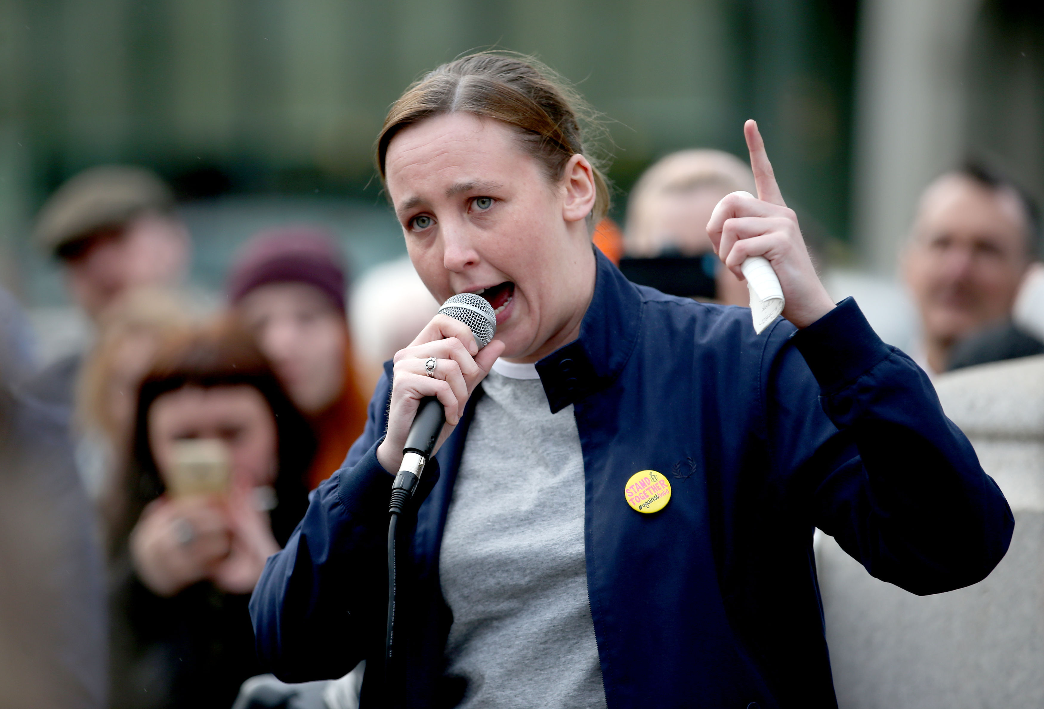 Mhairi Black pointing while speaking into a microphone at a rally