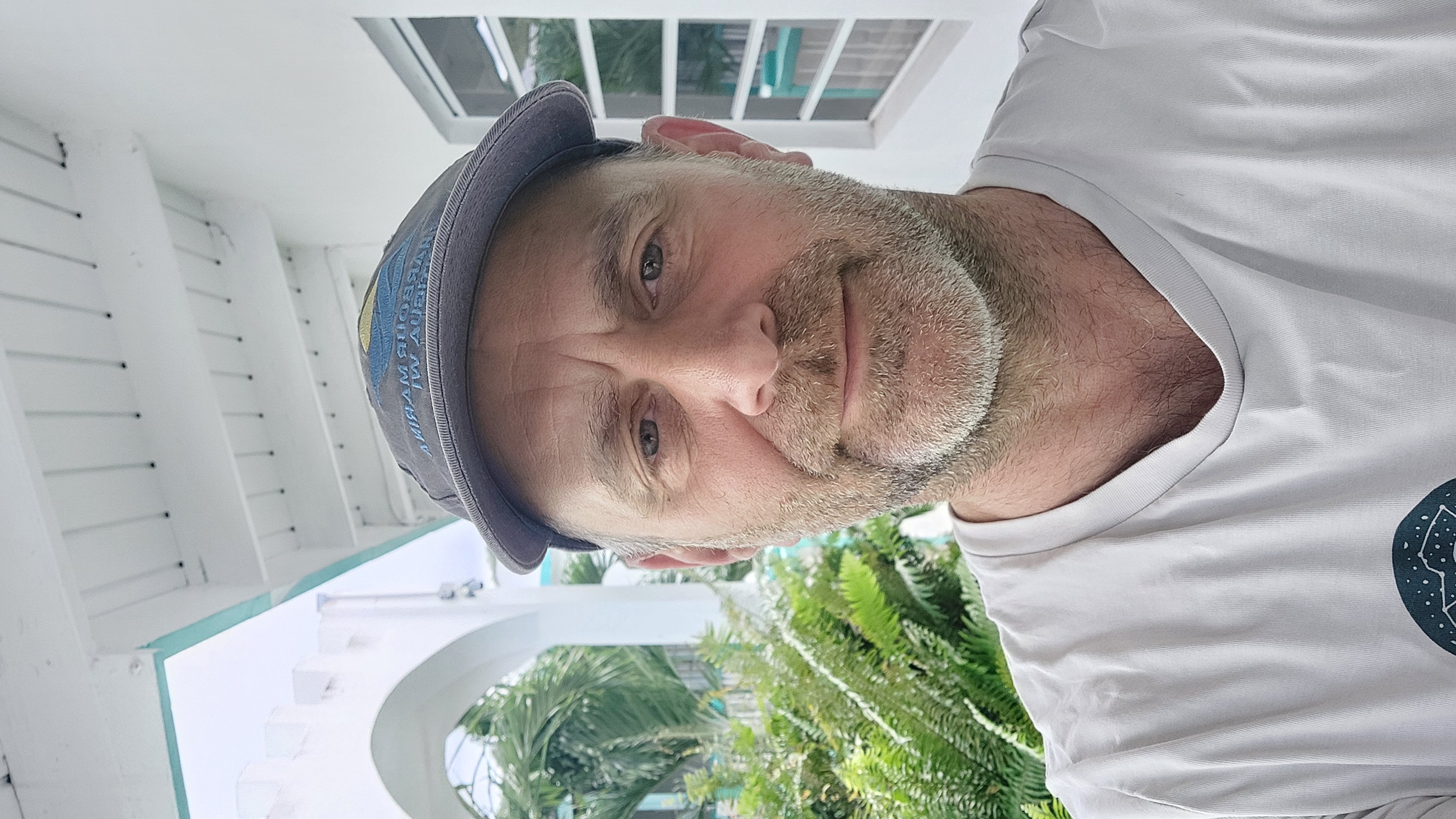 Close up selfie of a man wearing a grey cap