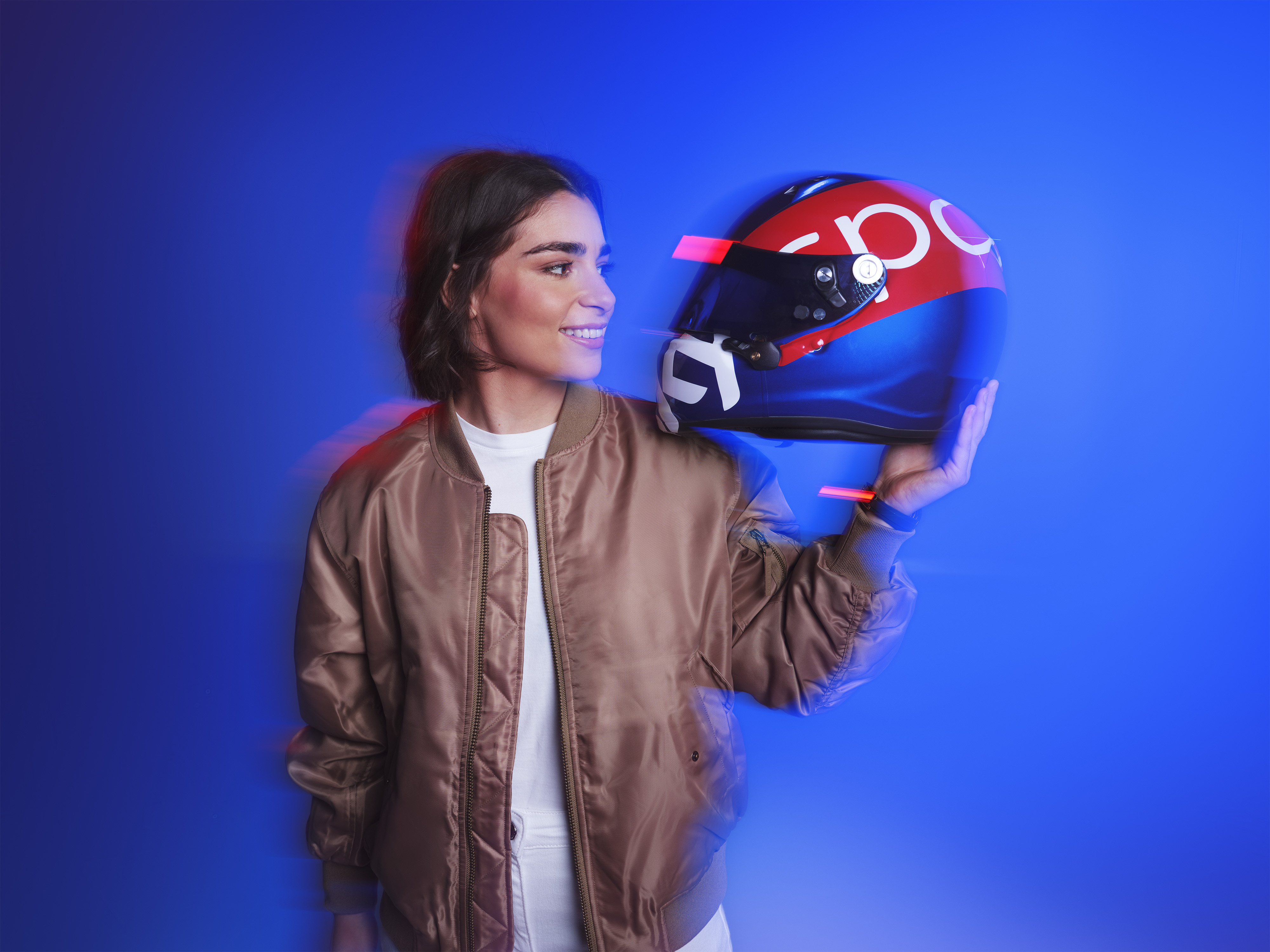 Jamie Chadwick looks at a crash helmet