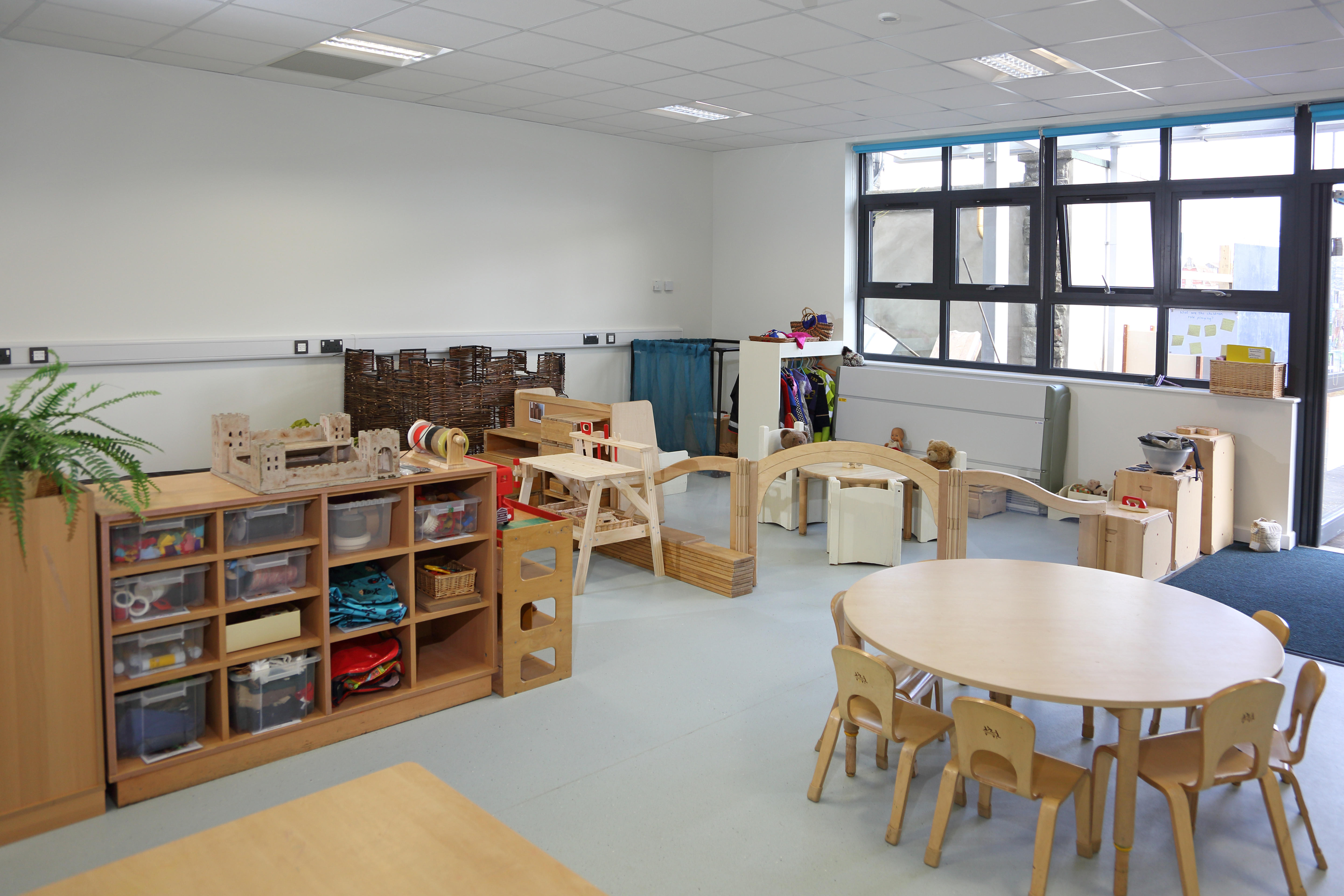 View of a room in an nursery, with empty tables and chairs and resources