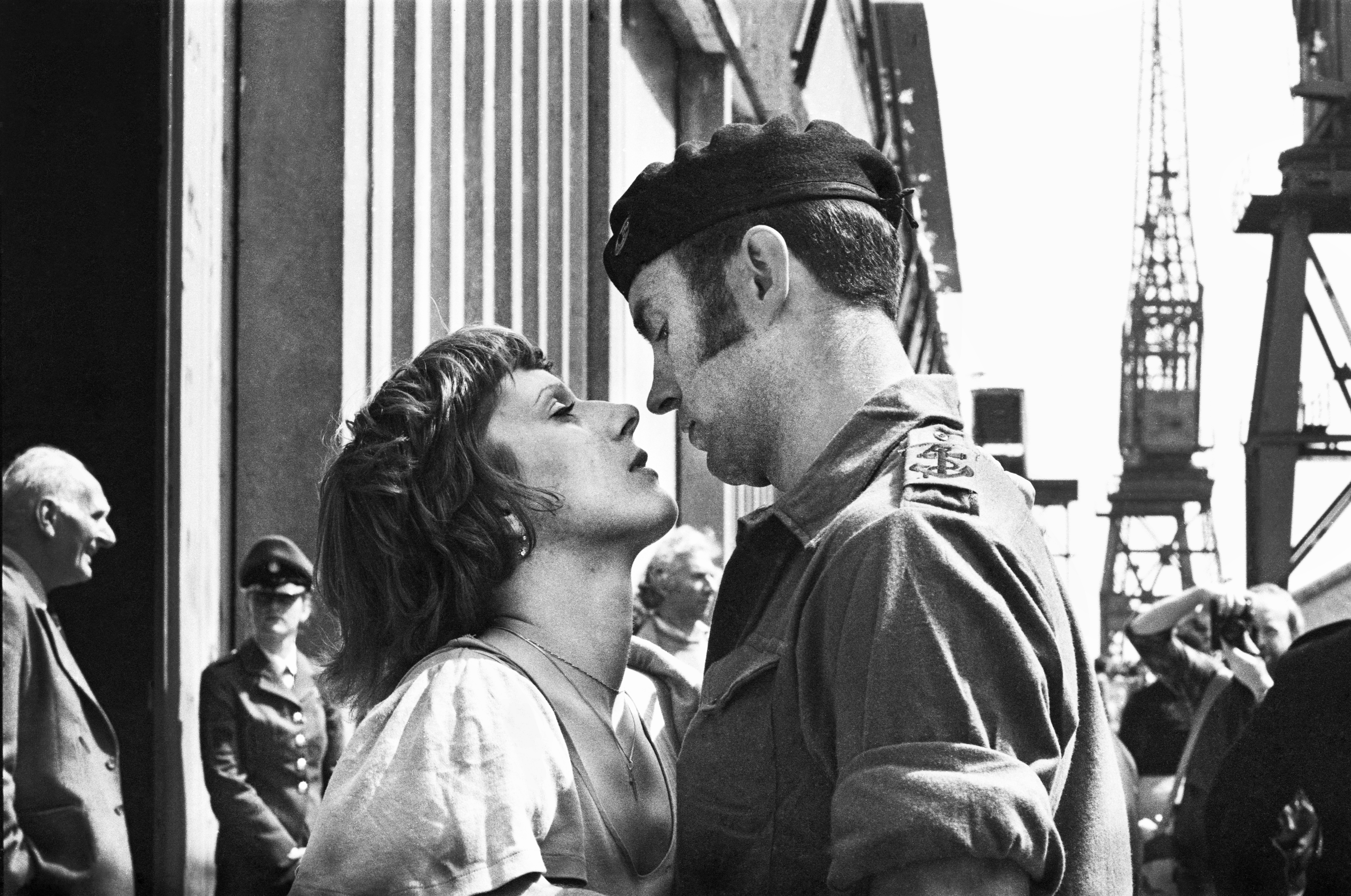 A couple lean in for a kiss as British troops are waved off at Southampton in 1982 (Mirrorpix/PA)