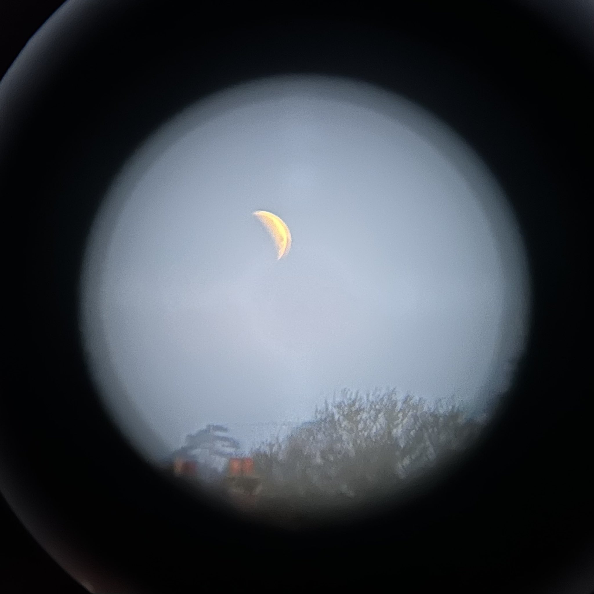 A picture of a blood moon taken through binoculars