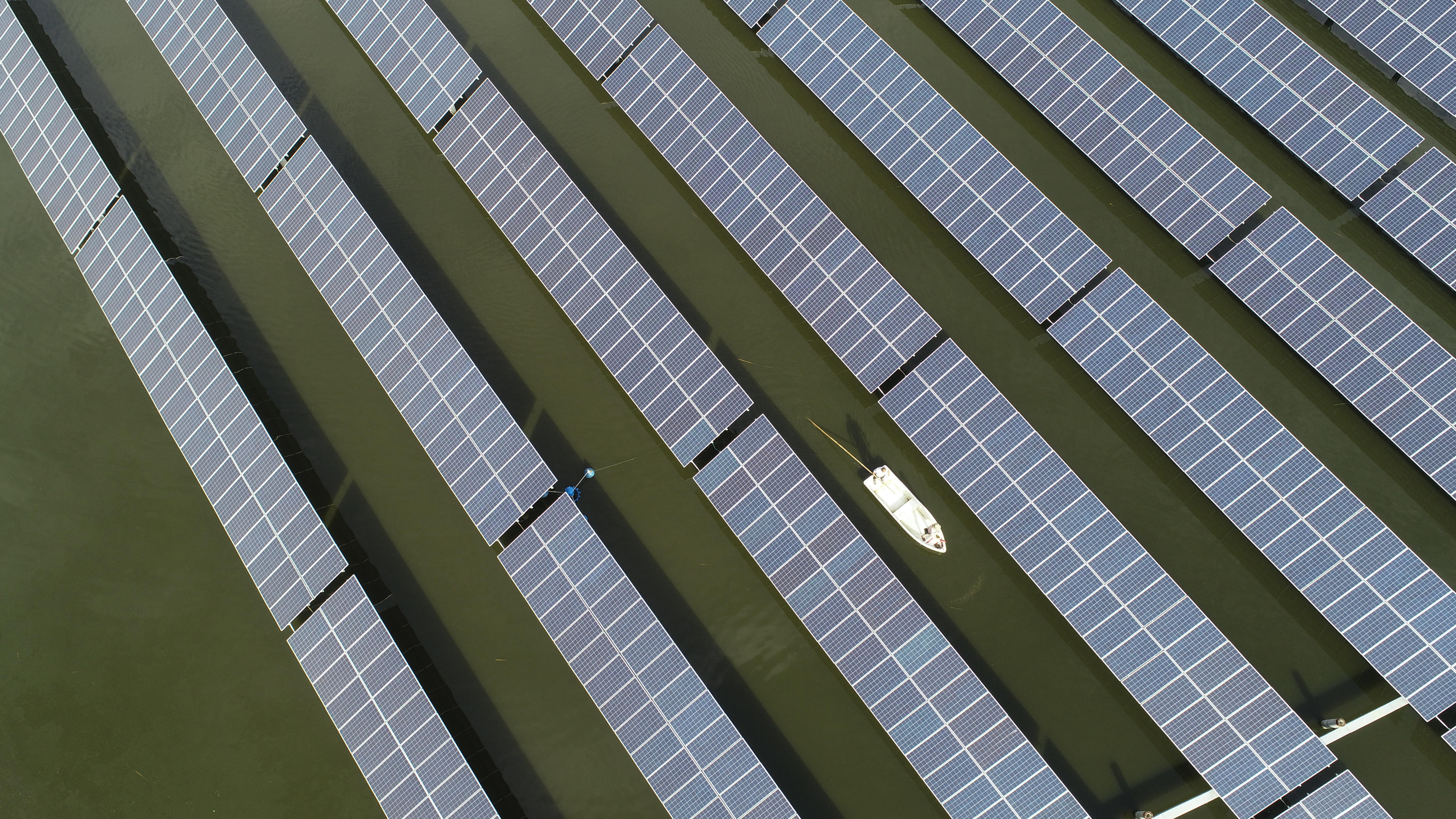 An aerial view of arrays of solar panels at a photovoltaic power station in a fishing farm in Donghai County, eastern China