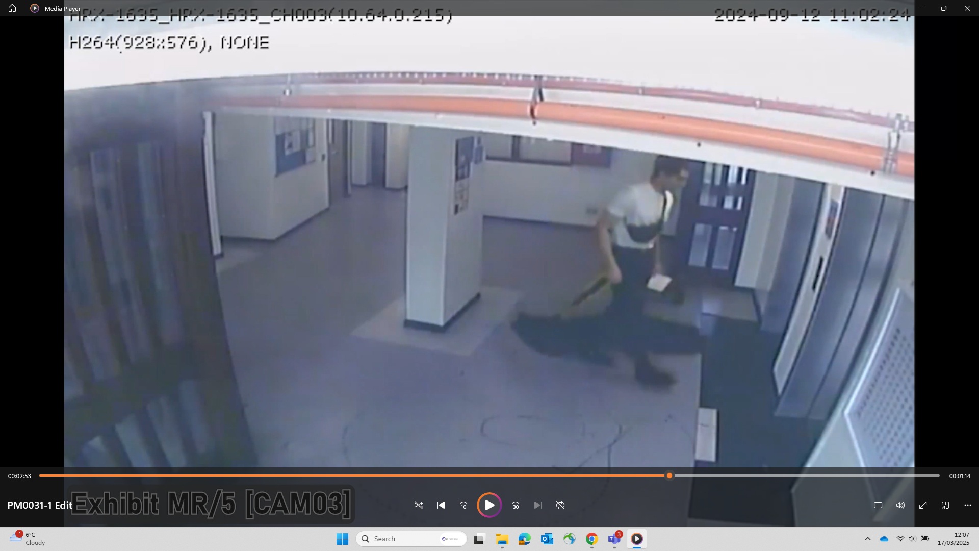 A CCTV still of Nicholas Prosper carrying a long dark holdall bag while waiting for a lift up to the flat where he lived 