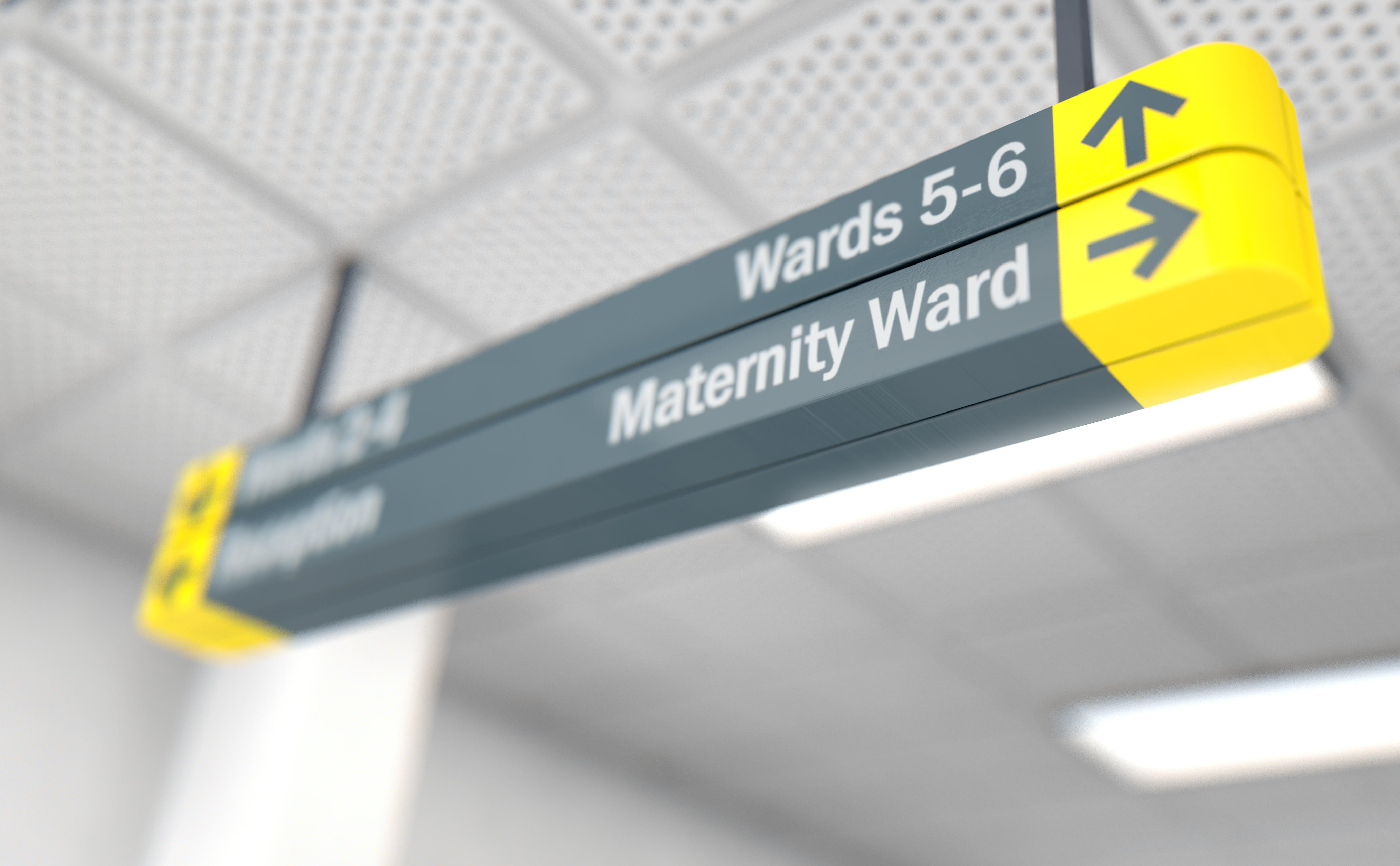 A ceiling mounted hospital directional sign highlighting the way towards the maternity ward