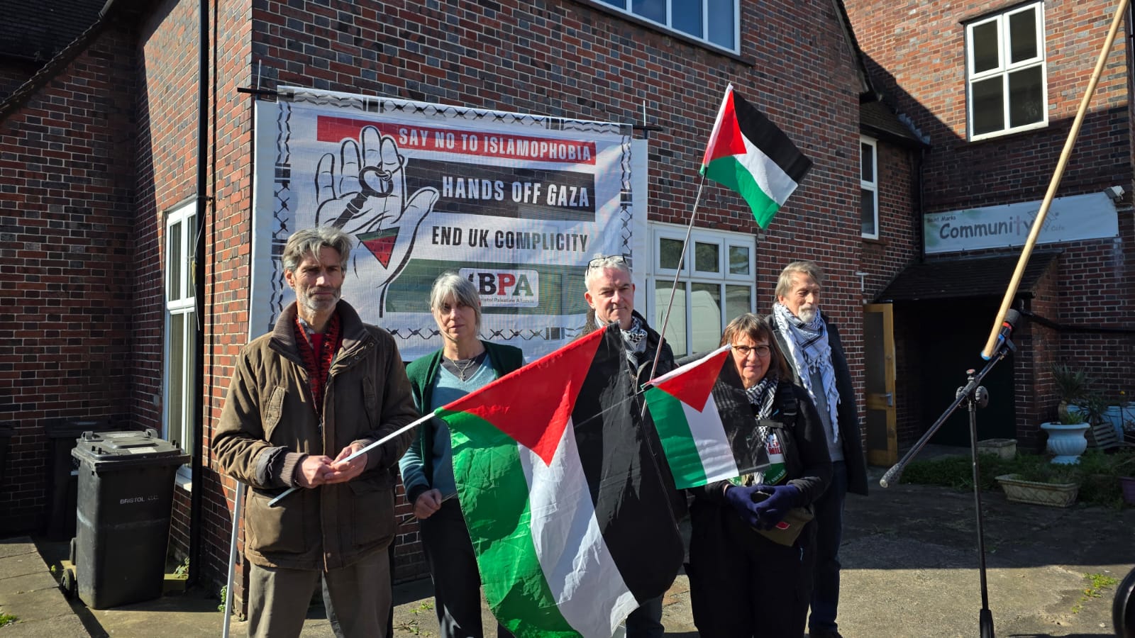 A group of people holding Palestine flags