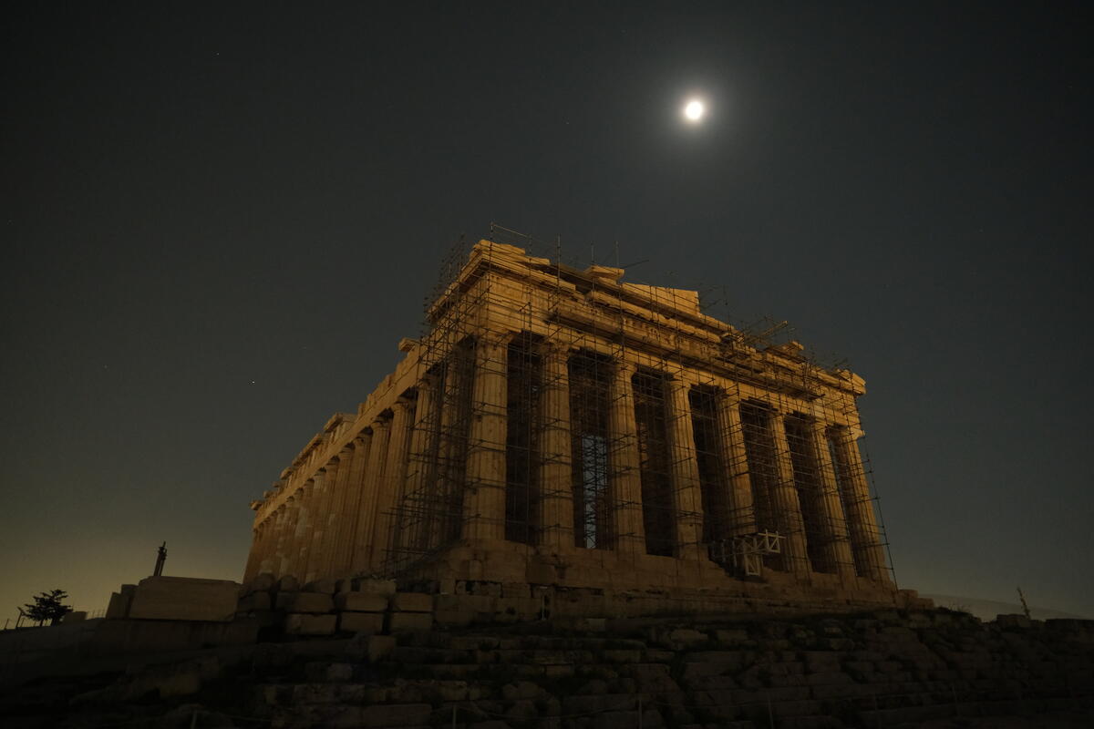 The Acropolis in Athens with its lights out under moonlight