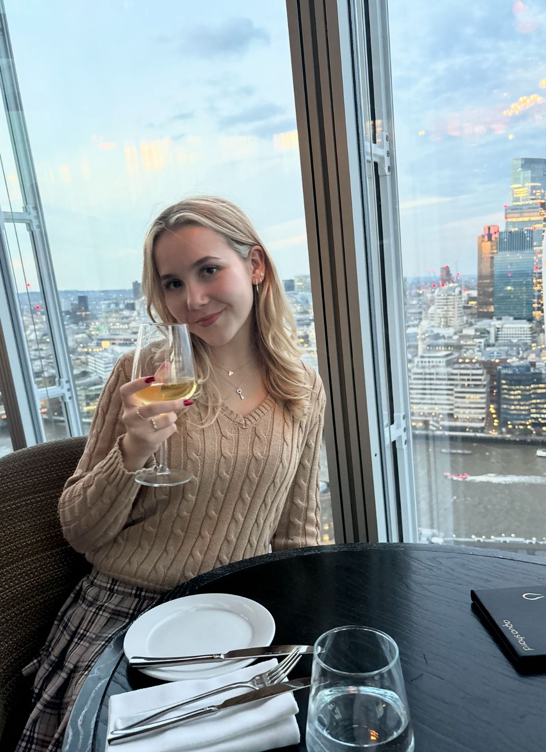 Charlotte Toller with a glass of alcohol in her hand 