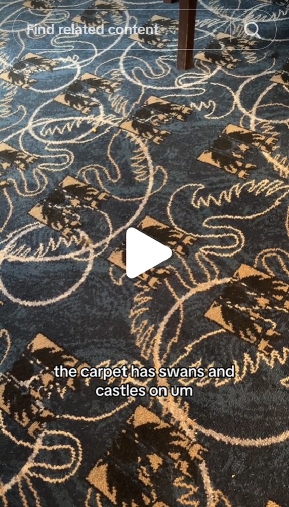 A pub carpet featuring a castle and swan design