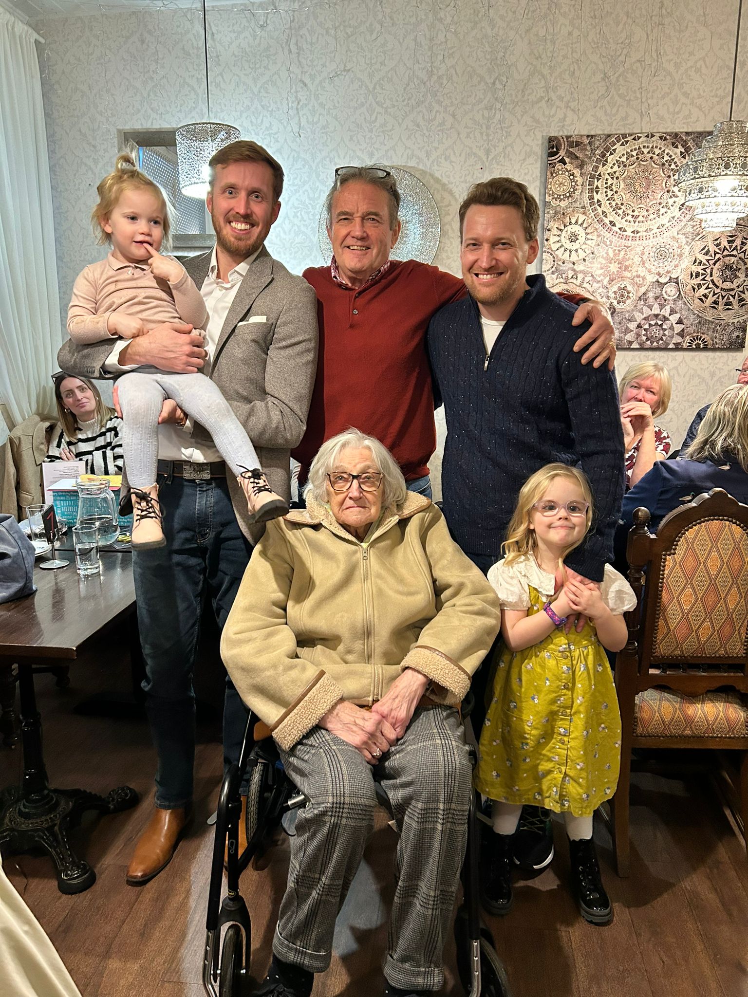 Bob standing amongst his family members 