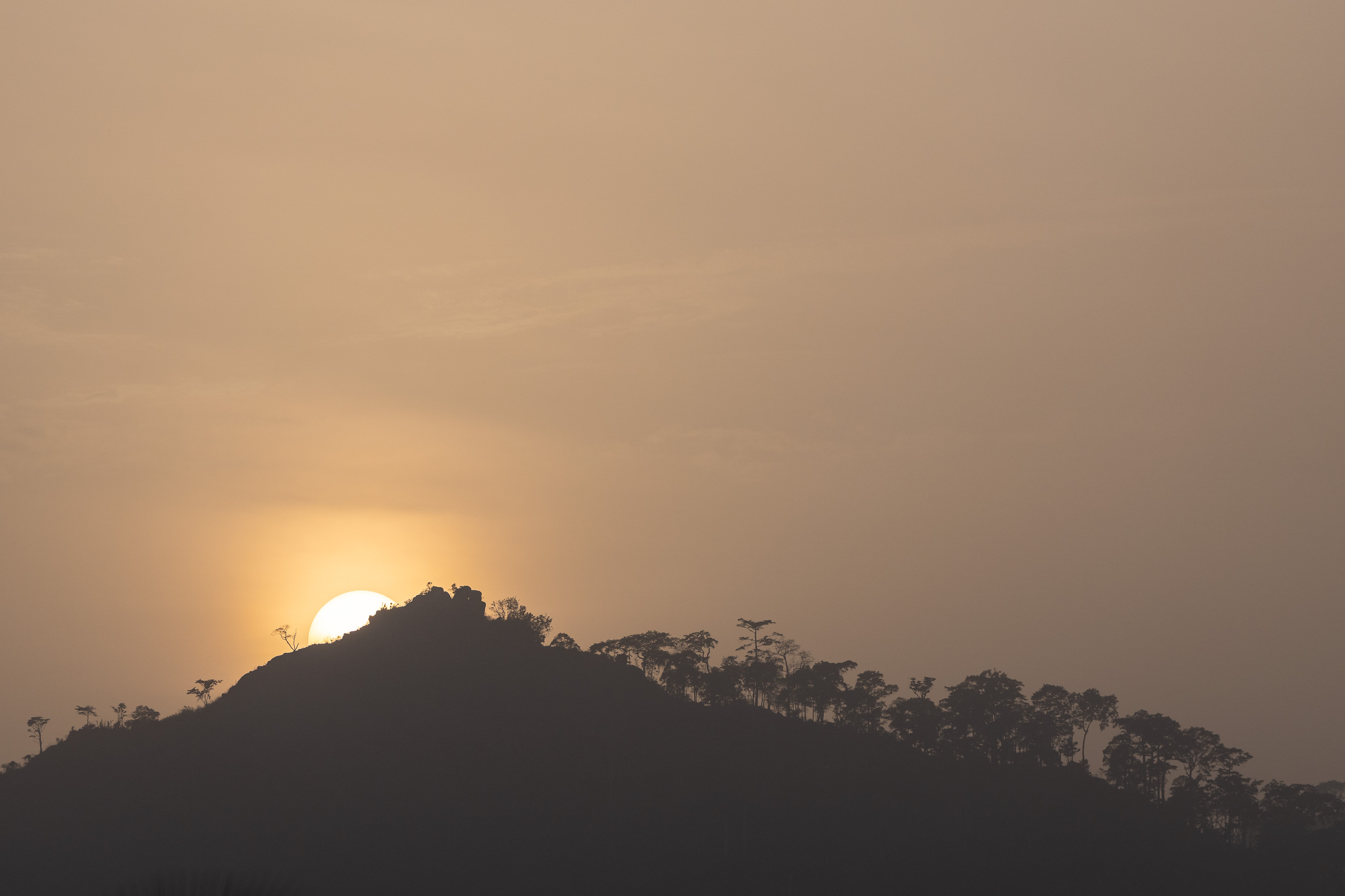 The sun sets over a hill above the city of Man, Ivory Coast.